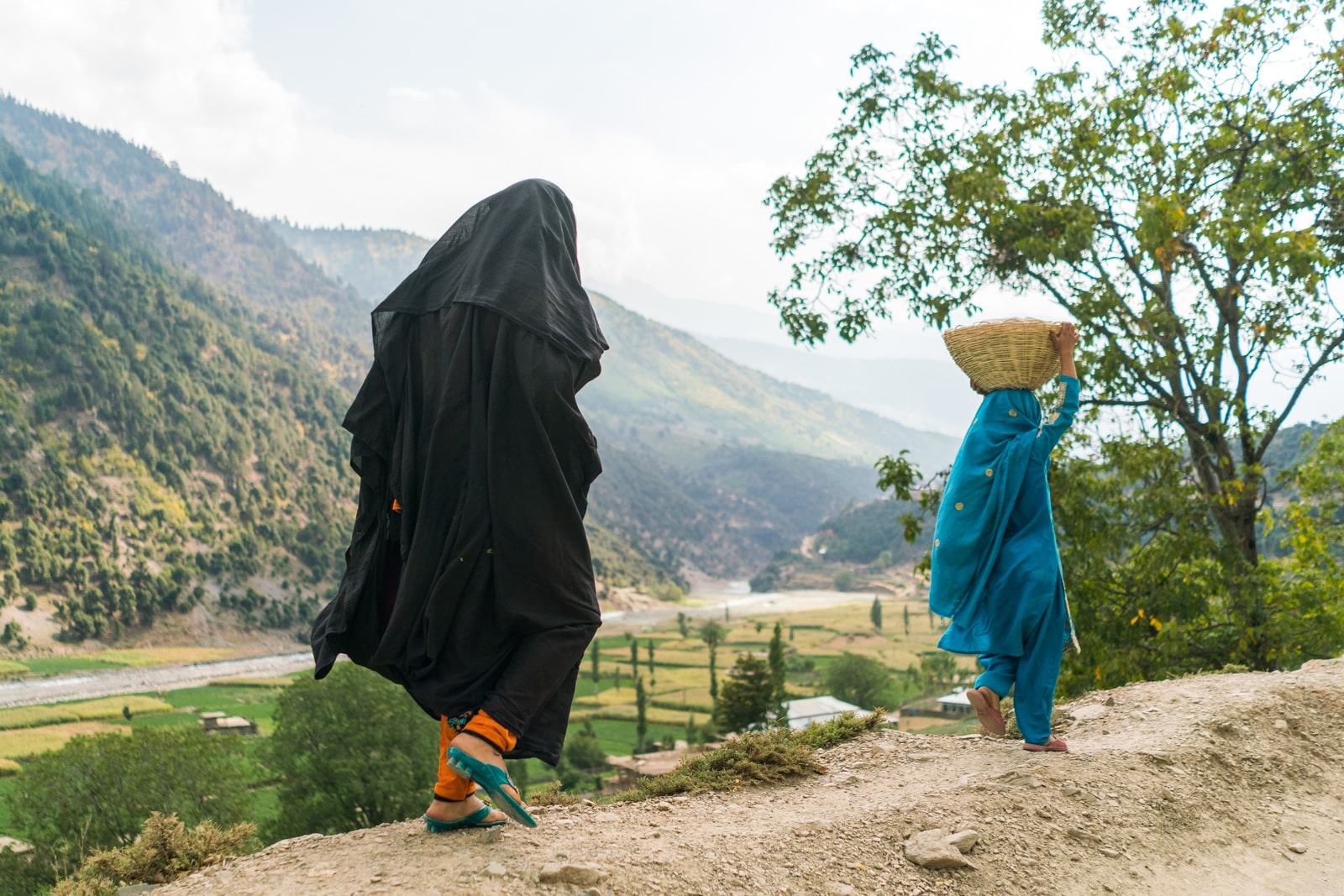 The great divide in Thall, Pakistan - Woman walking in black - Lost With Purpose travel blog