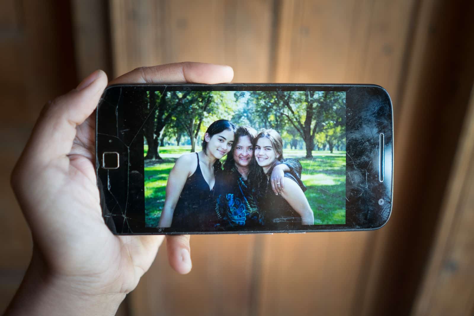 The great divide - A photo of Alex, her mother, and her best friend on her mobile - Lost With Purpose travel blog