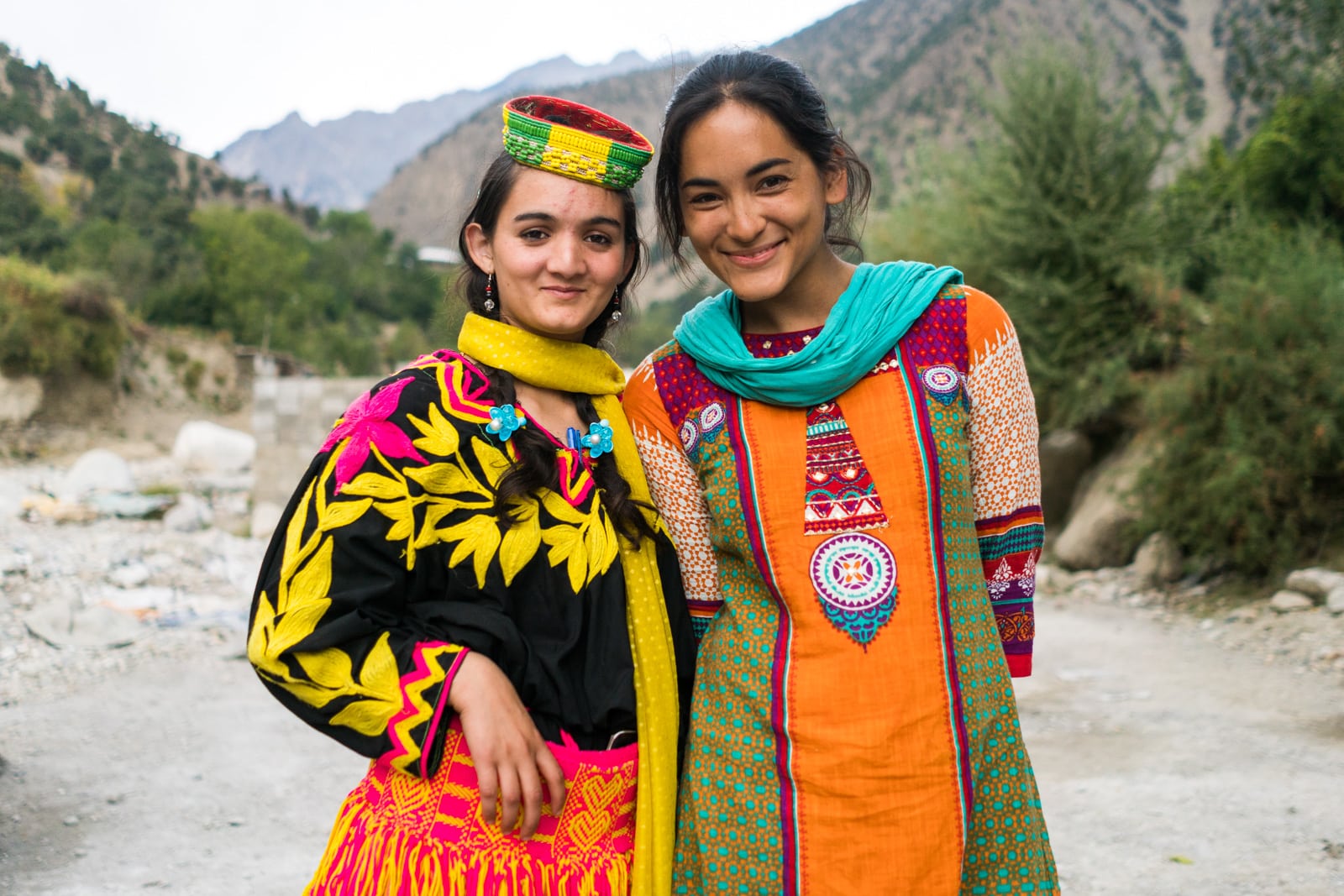 Foreign visitor posing with a Kalasha girl