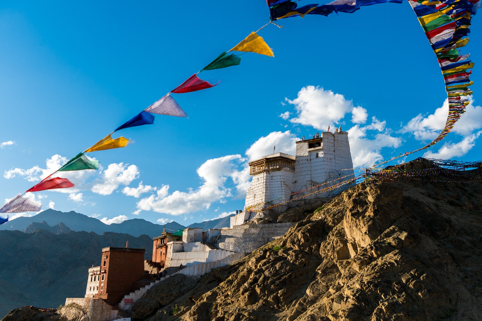 Short 3-day itinerary and guide to the Sham Valley trek in Ladakh, India - Monastery in Leh at sunset with prayer flags - Lost With Purpose travel blog