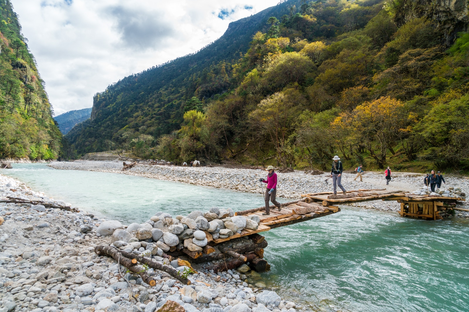 Photos of the Gasa - Laya trek in Bhutan - Tour group crossing a bridge on the river en route to Laya - Lost With Purpose travel blog