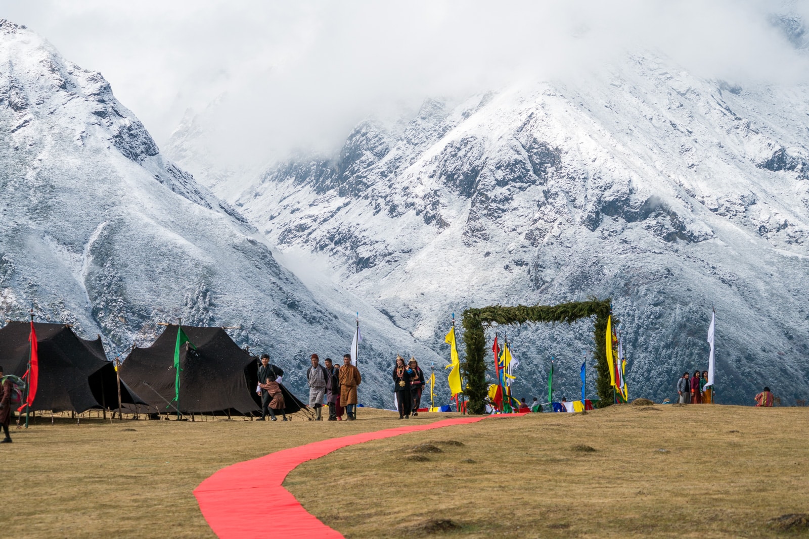 Photos of the 2017 Royal Highlander Festival in Bhutan - Entrance to the festival grounds with snowy Himalayas in the background - Lost With Purpose travel blog