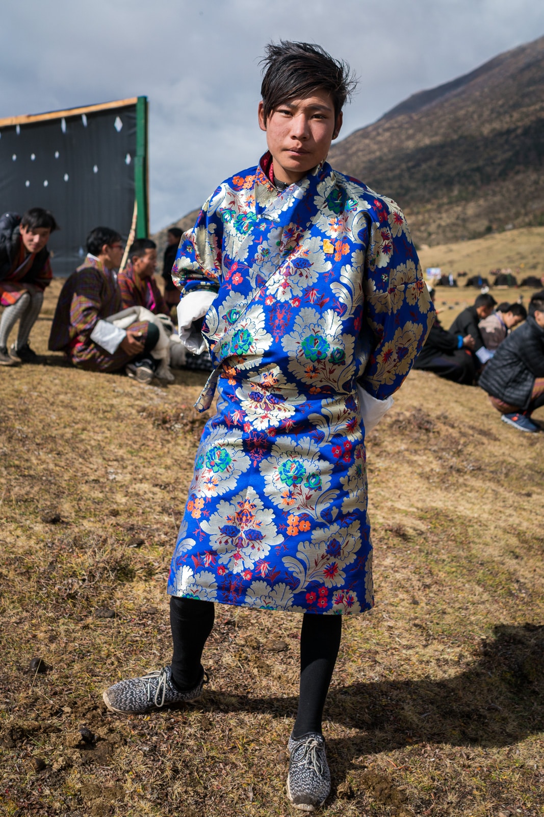 Talk about crazy patterns! A Bhutanese boy in a silver and blue "gho", traditional male Bhutanese dress, at the 2017 Royal Highlander Festival in Laya, Bhutan.