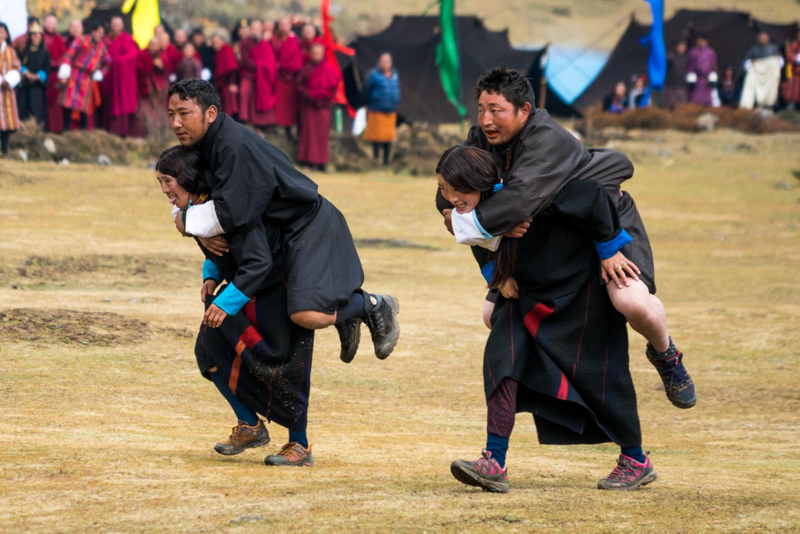 Photos of the 2017 Royal Highlander Festival - Girls carrying boys in a relay race at the Royal Highlander Festival - Lost With Purpose travel blog