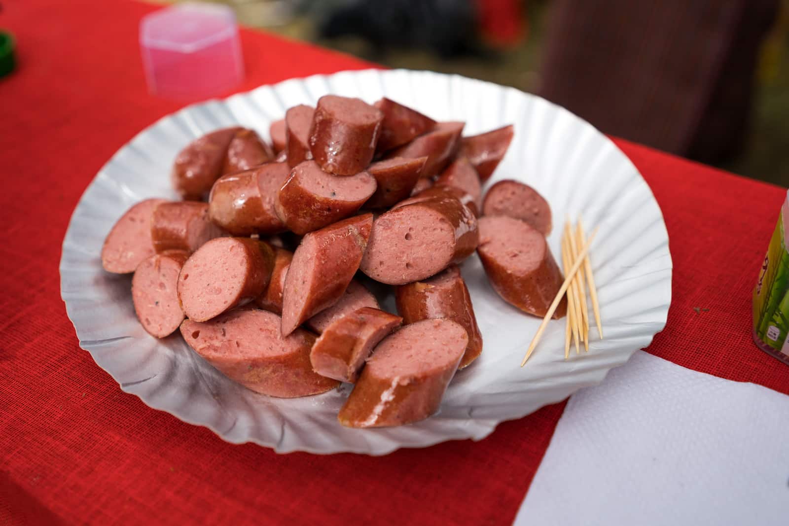 Food at the Royal Highlander Festival in Bhutan - Hot yak sausage slices - Lost With Purpose travel blog