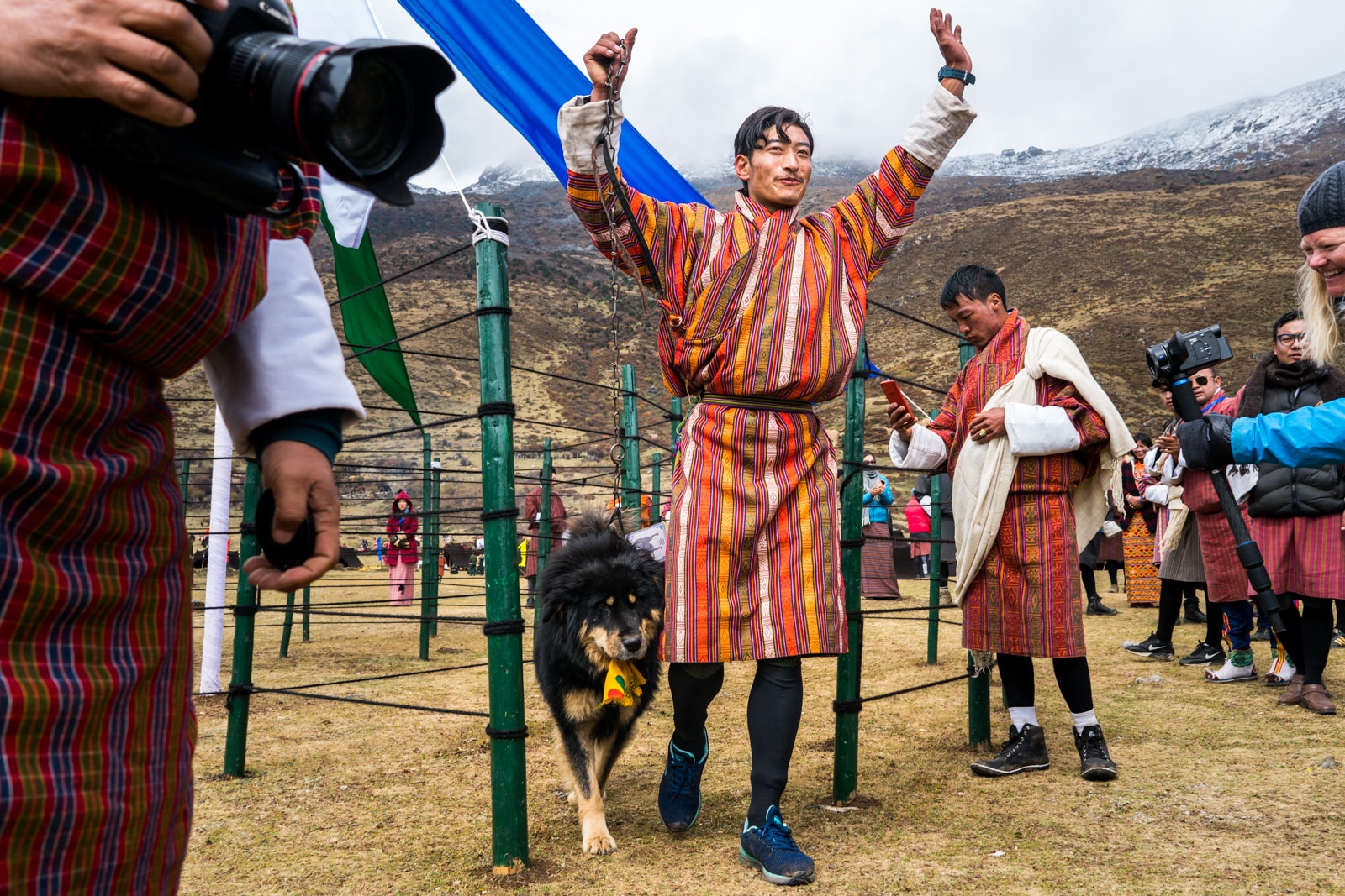 Photos of the 2017 Royal Highlander Festival in Laya, Bhutan - Man showing a prize winning Himalayan mastiff at the festival - Lost With Purpose travel blog