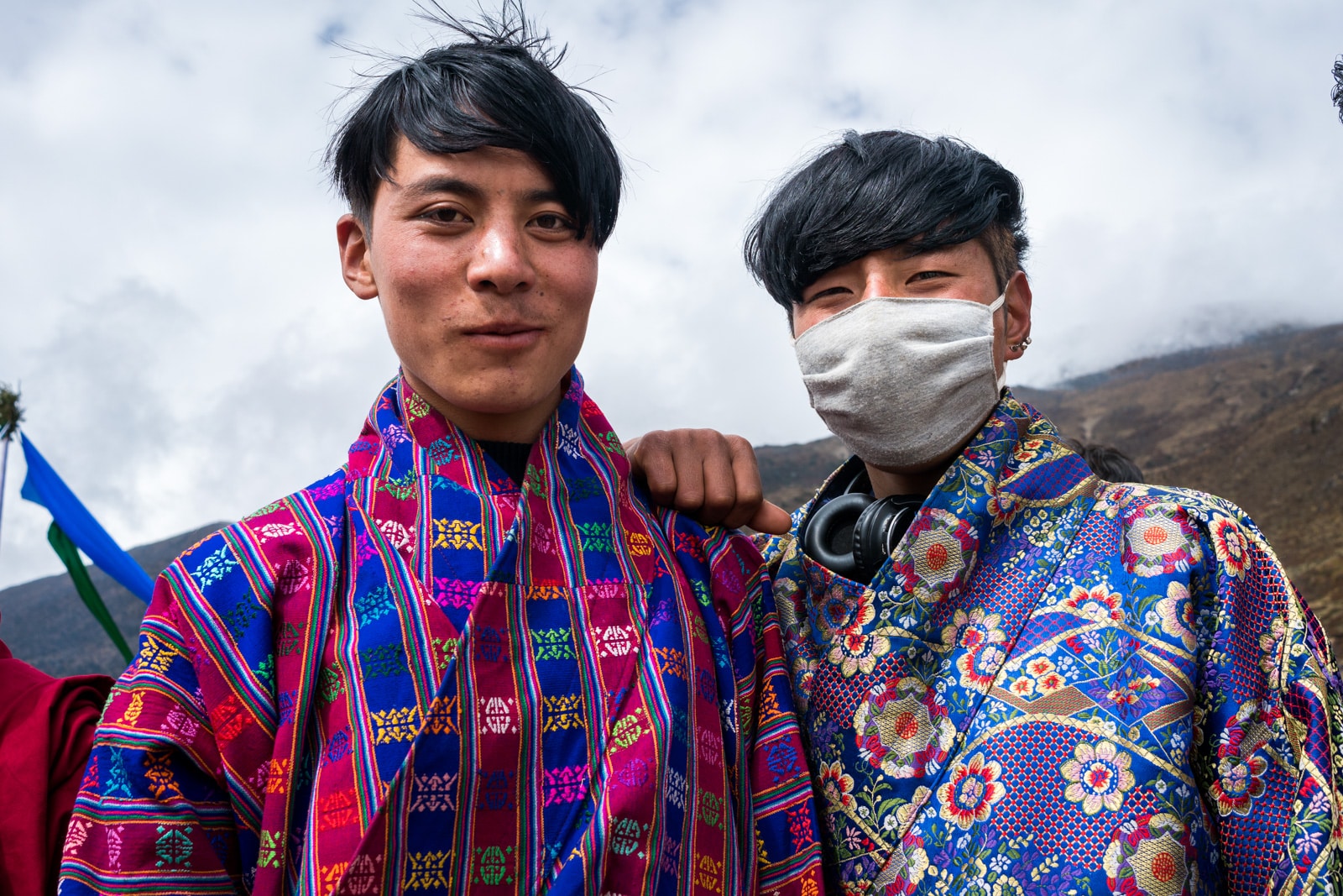 Photos of the 2017 Royal Highlander Festival in Bhutan - Young hip boys posing in colorful patterned gho, traditional male Bhutanese dress - Lost With Purpose travel blog