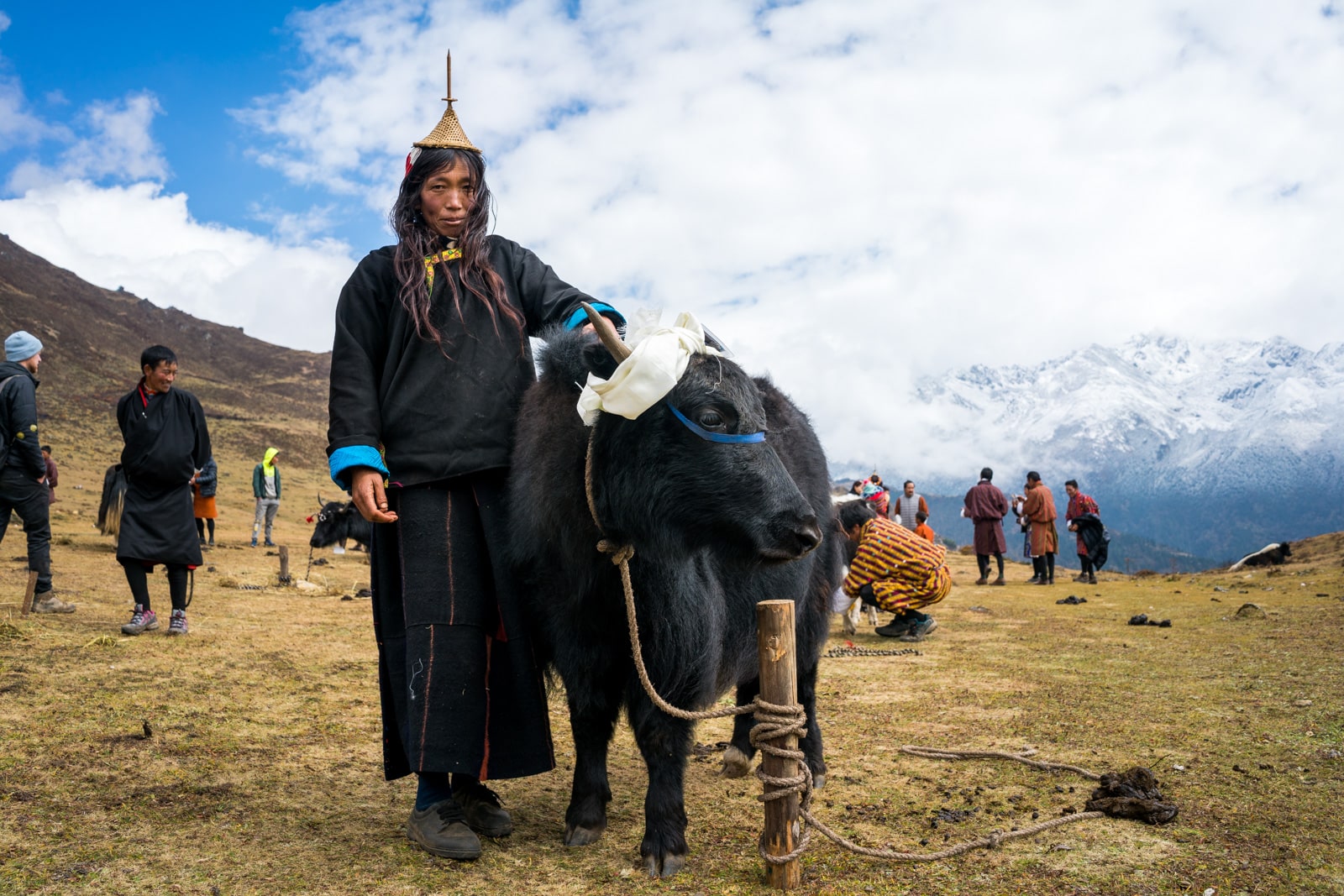 Photos from the 2017 Royal Highlander festival in Laya, Bhutan - Layap woman posing with her cow - Lost With Purpose travel blog