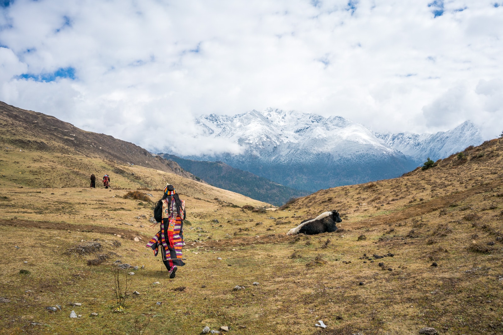 Photos of the Royal Highlander Festival in Bhutan - Layap woman in traditional clothes walking in the Himlayan mountains - Lost With Purpose travel blog