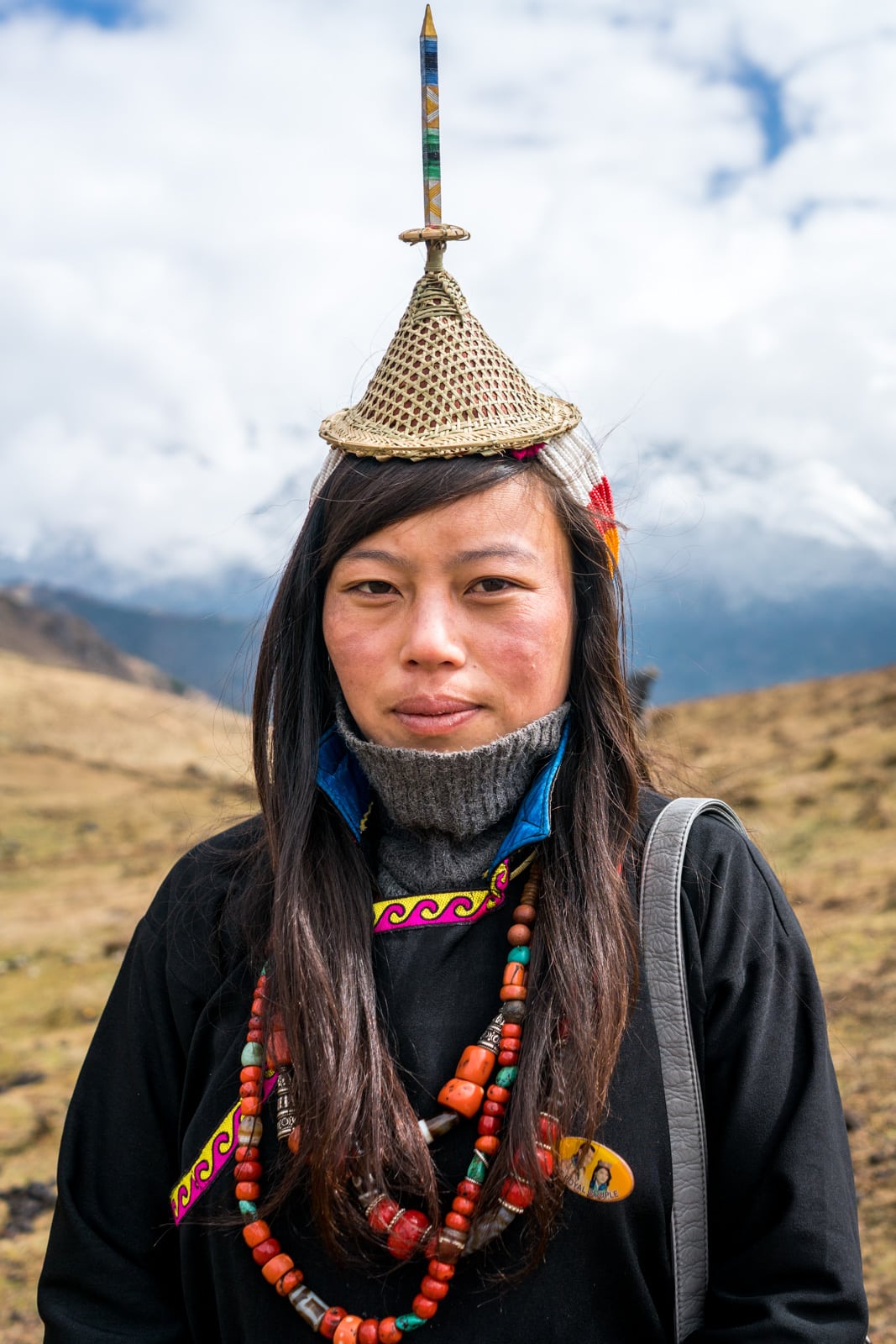 Portrait of a Layap woman in her traditional headdress and clothes at the Royal Highlander Festival in Bhutan. The festival, filled with local people in their best traditional Bhutanese dress, is a dream for anyone interested in Bhutan photography!