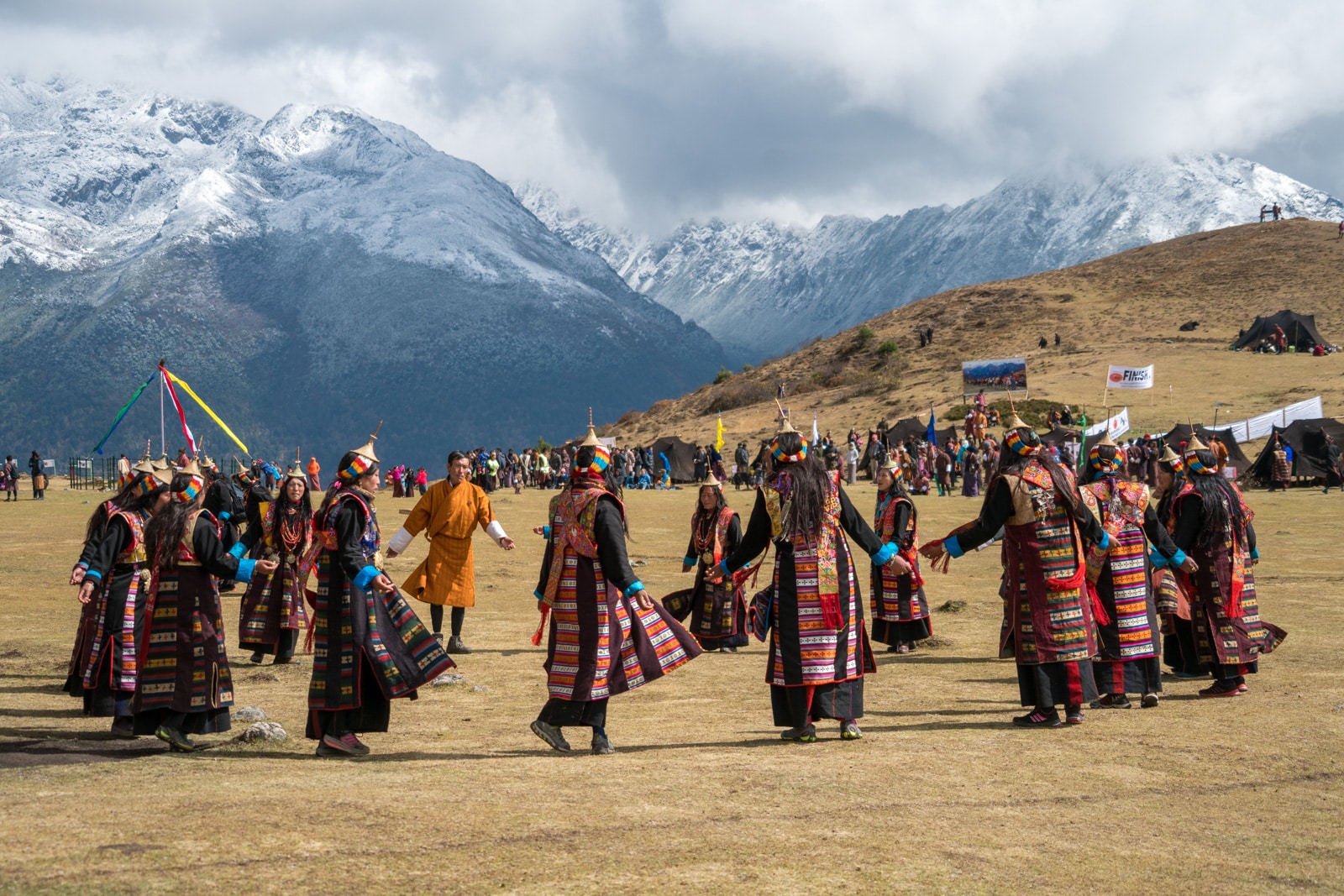 Photos of the 2017 Royal Highlander Festival in Bhutan - Women dancing in a circle at the festival - Lost With Purpose travel blog