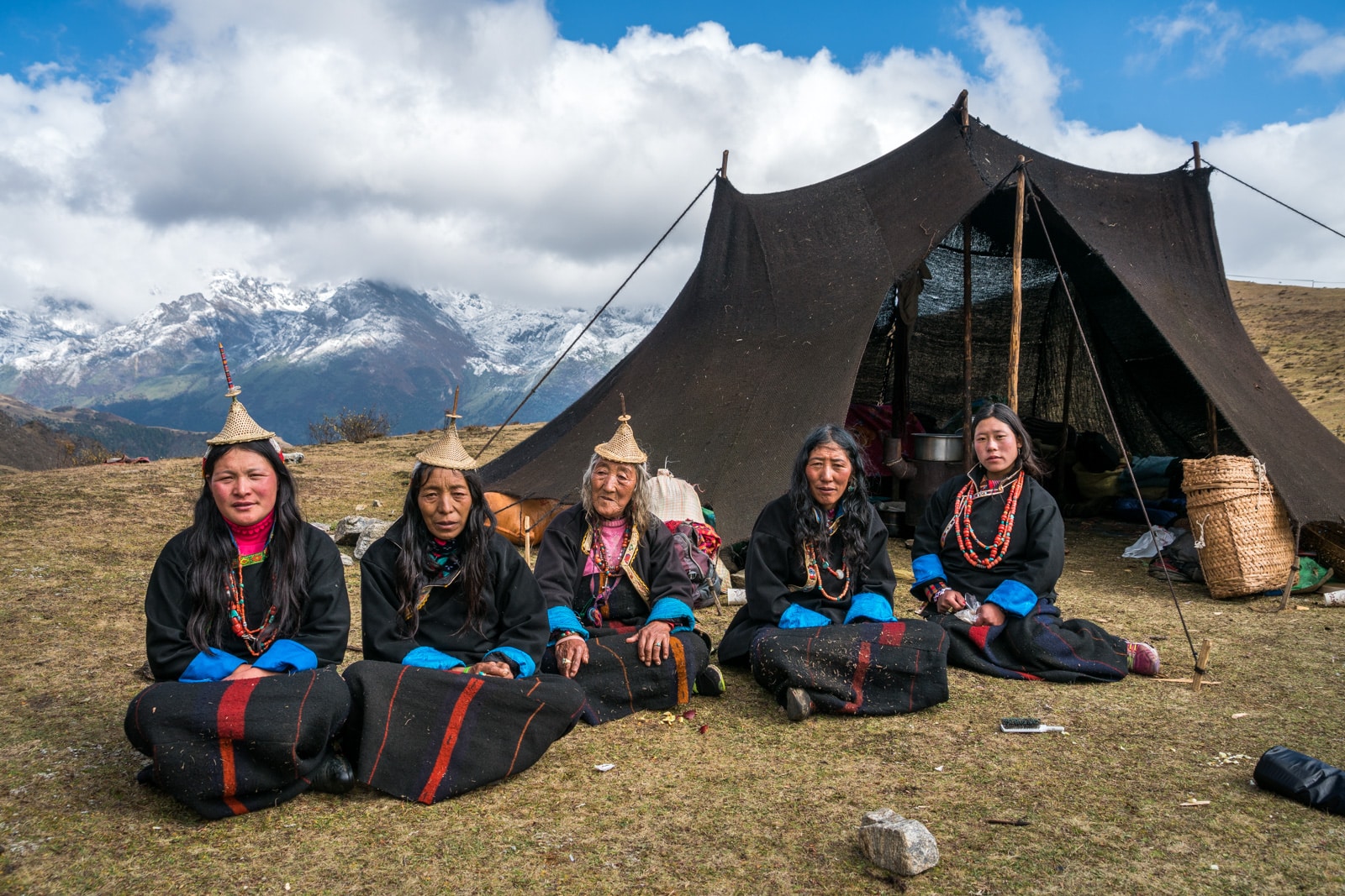 Photos of Layaps at the Royal Highlander Festival in Bhutan - Local Layap women sitting in front of a traditional black yak hair tent in Laya - Lost With Purpose travel blog