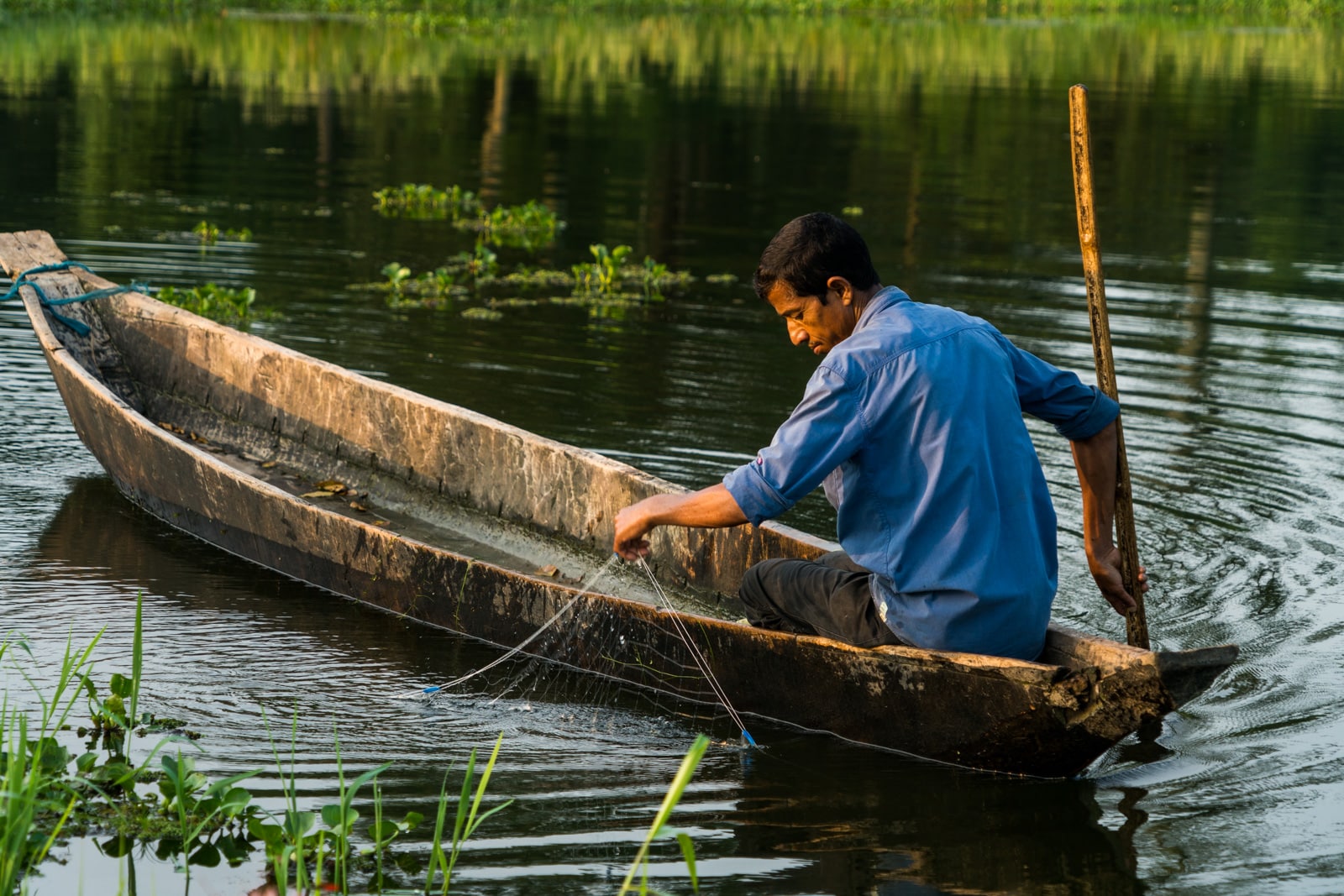 Fisherman in a boat checking nets