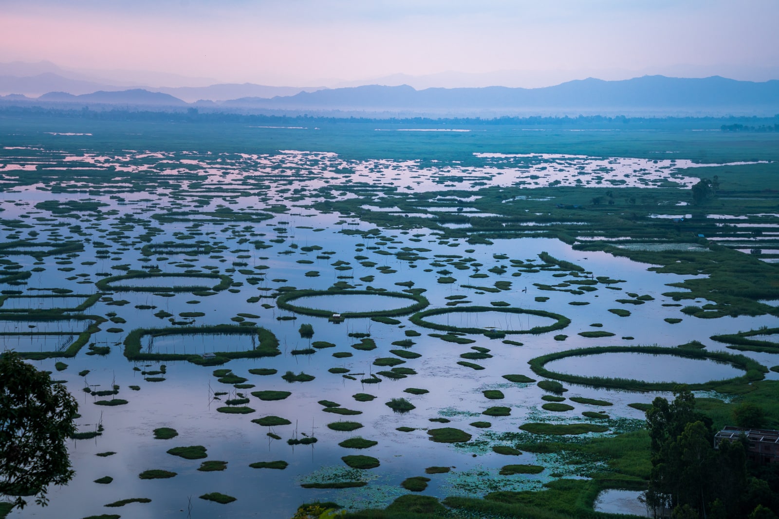 Our favorite off the beaten path destinations in India - Pastel pink sunrise over Loktak Lake in Manipur - Lost With Purpose travel blog