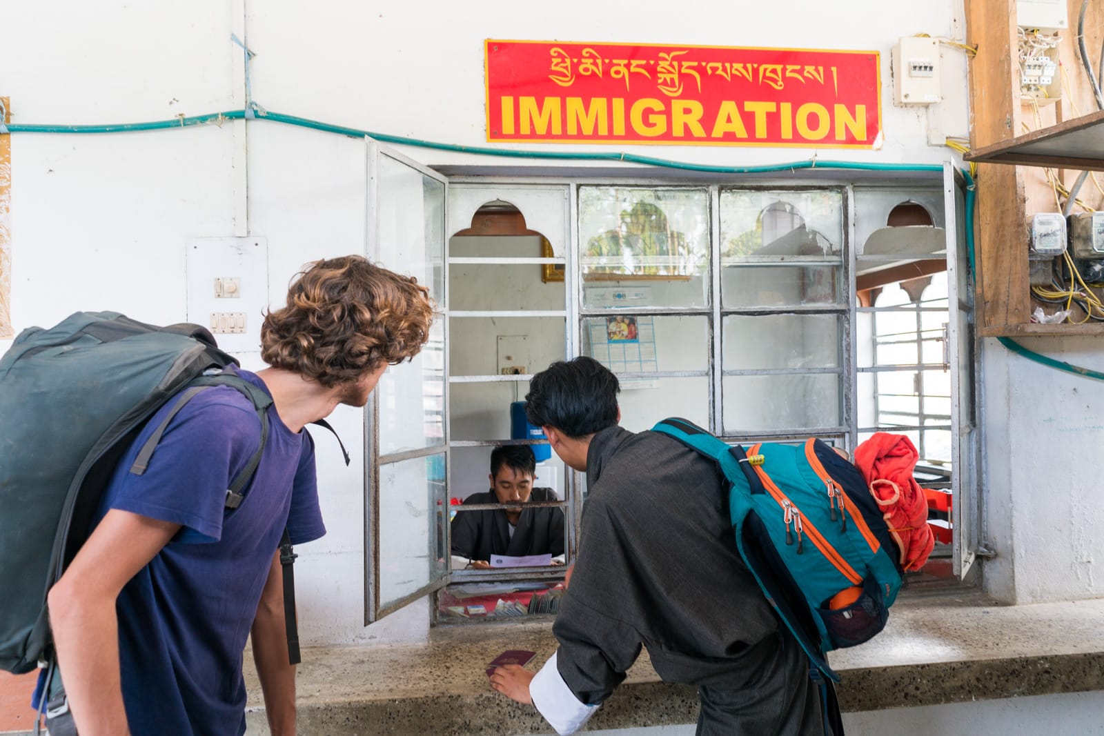 Passing through the immigration post at the India - Bhutan border crossing at Gelephu with our Gray Langur Tours guide - Lost With Purpose travel blog