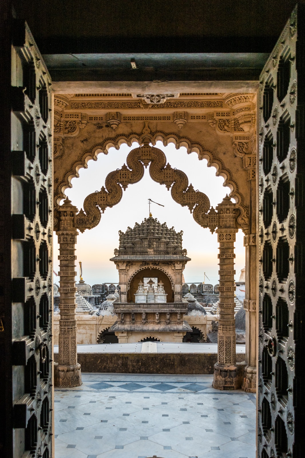 Temple doors opening to sunrise over the Jain temples of Palitana, Gujarat state, India. The perfect off the beaten track destination for your India trip!