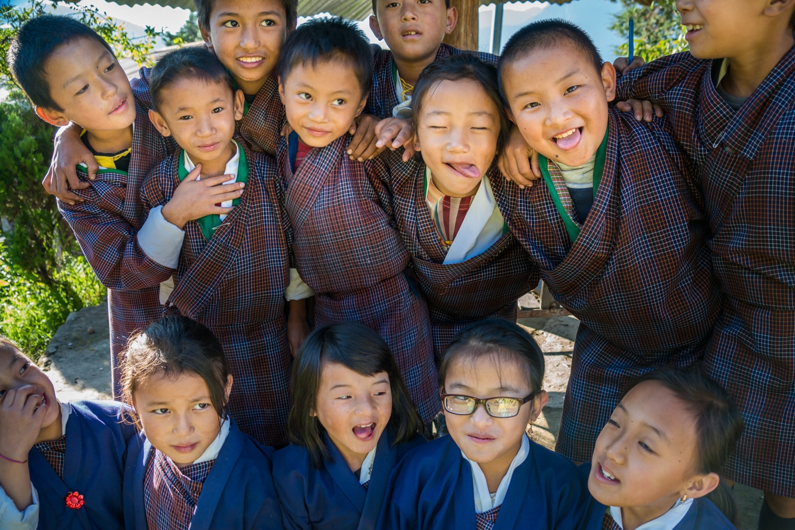 Our experience going on a guided tour in Bhutan - School children making faces in Kuengarabten - Lost With Purpose travel blog