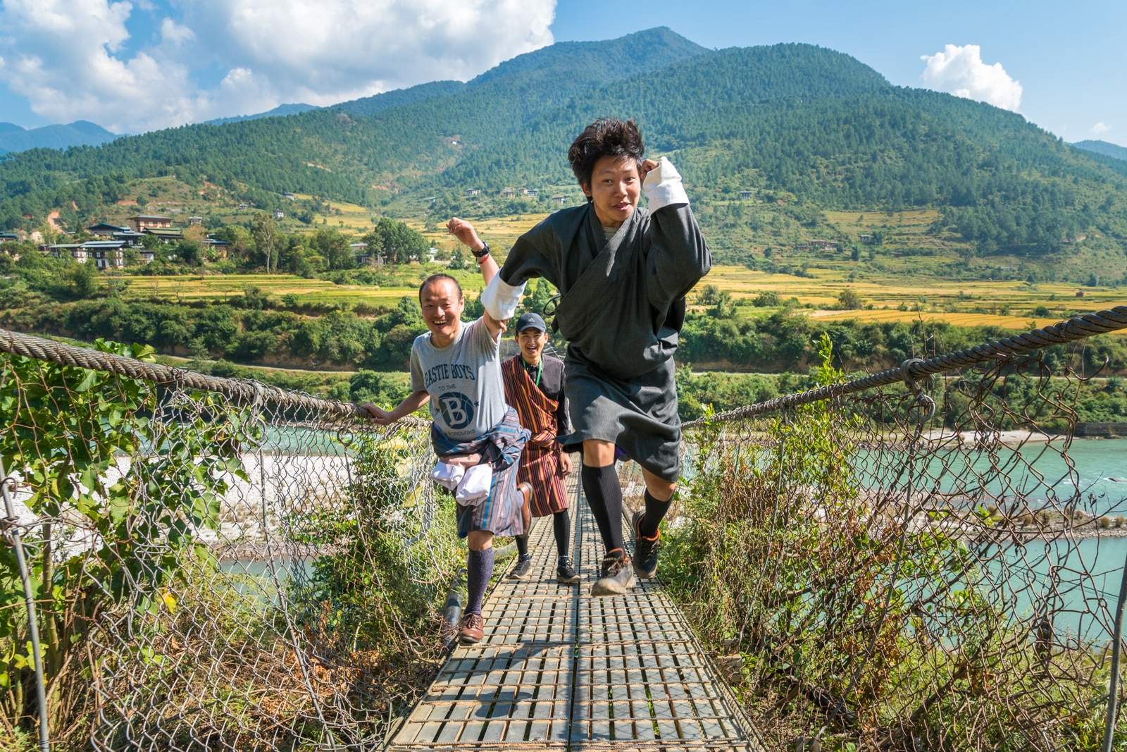 A good review of tour guides in Bhutan - Karma and the group tour guides on the suspension bridge in Punakha - Lost With Purpose travel blog