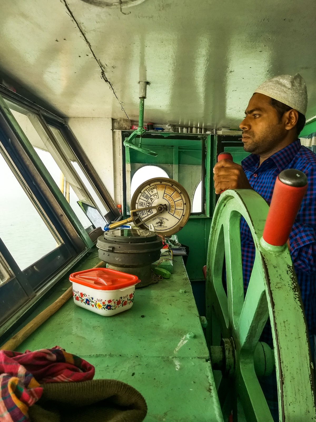 how to get from Chittagong to Barisal by boat in Bangladesh - Captain driving launch from Chittagong - Lost With Purpose travel blog