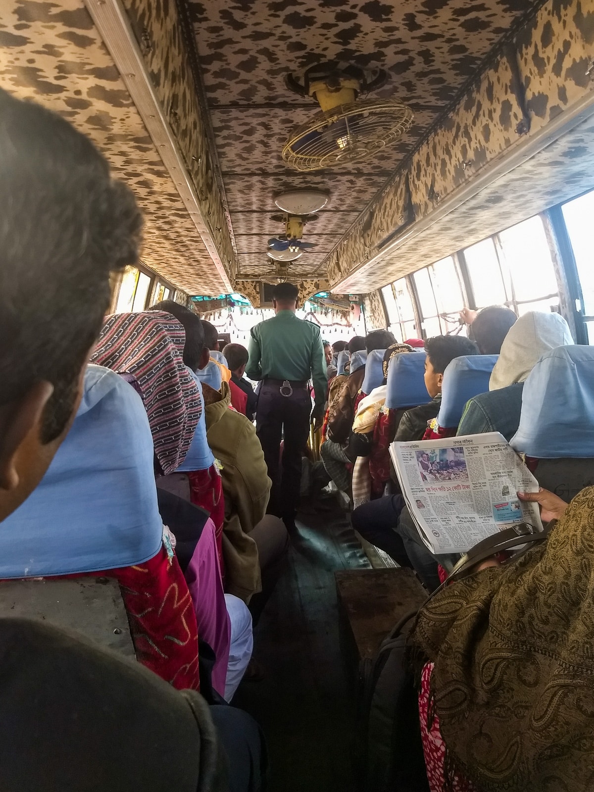 Crossing the India - Bangladesh border at Petrapole and Benapole - Police officer checking the bus - Lost With Purpose travel blog