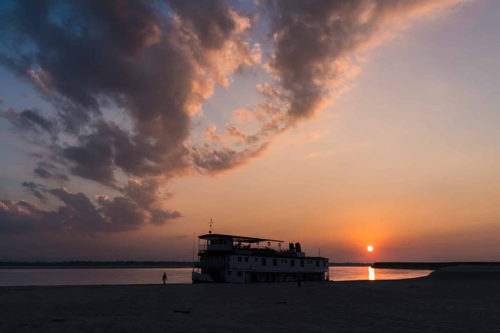 Luxury Indian river cruise on the Brahmaputra with Assam Bengal Navigation - Boat silhouette and sunset on the river - Lost With Purpose travel blog