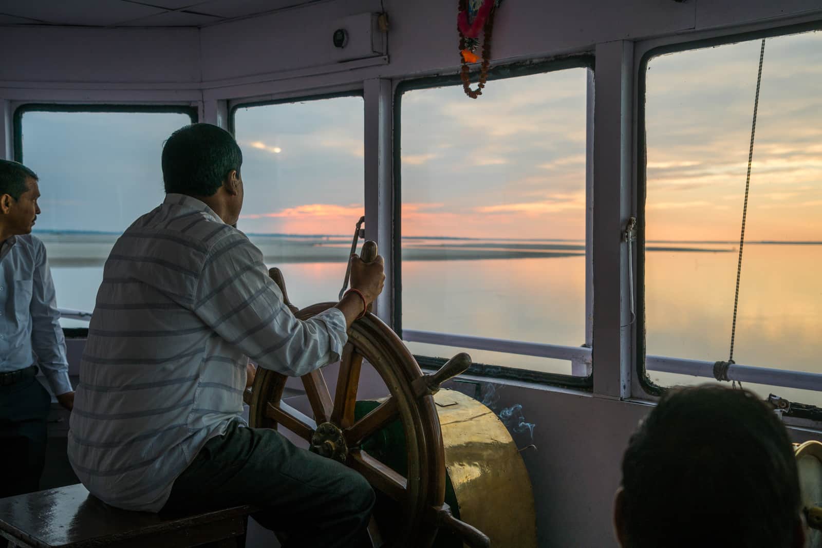 River cruising with Assam Bengal Navigation - Captain at the old steering wheel - Lost With Purpose travel blog