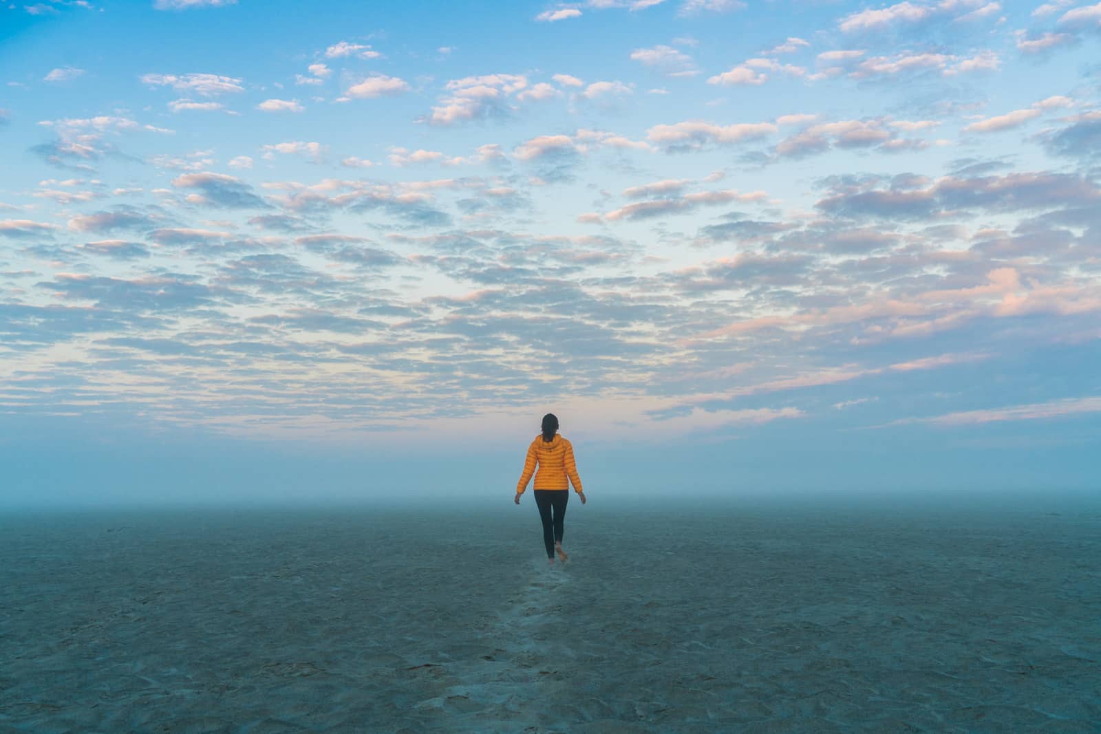 Breaking up on the road - Alex walking into the mist on the Brahmaputra river in Assam, India - Lost With Purpose travel blog