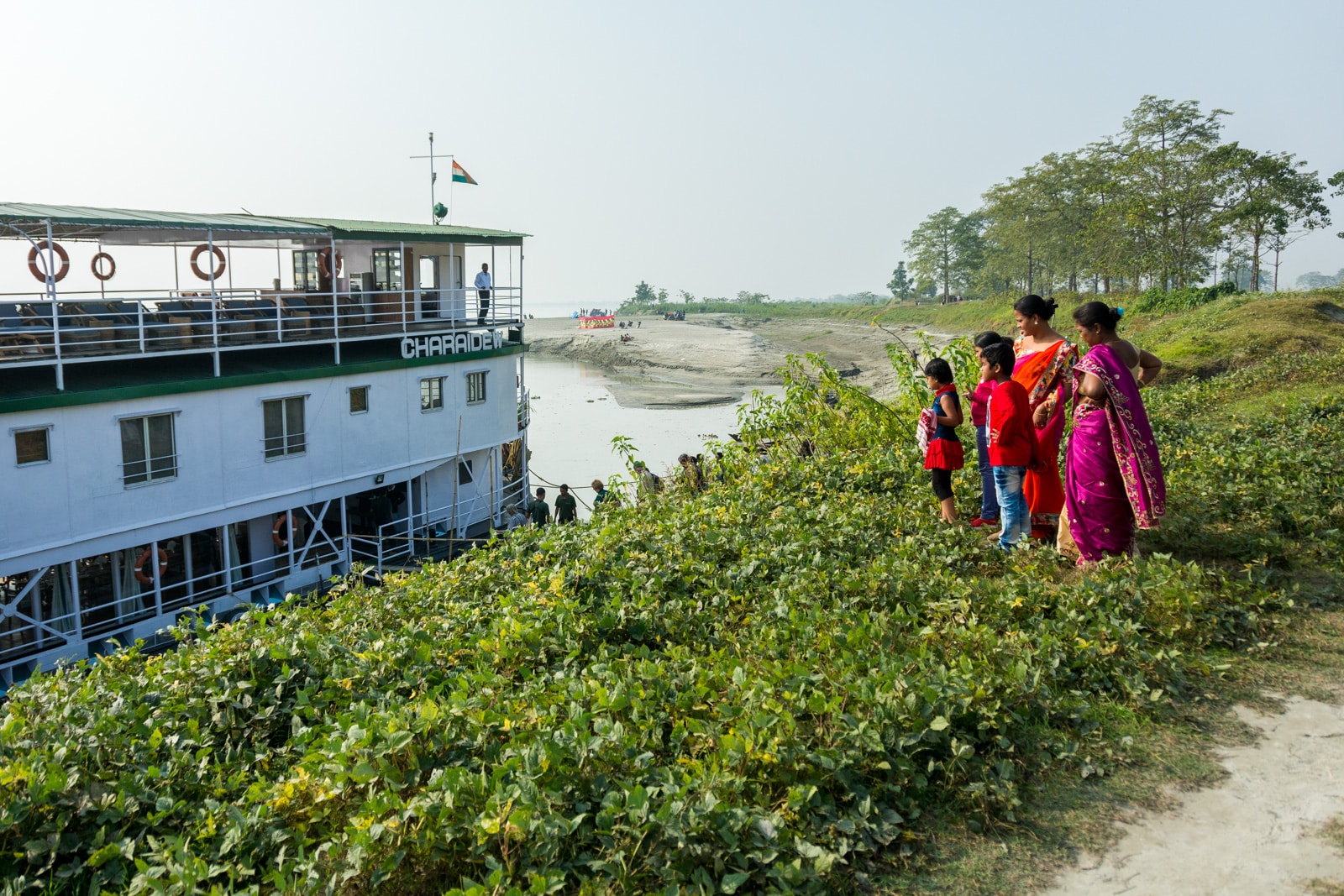 River cruise in India with Assam Bengal Navigation - Local women checking out the cruise boat - Lost With Purpose travel blog