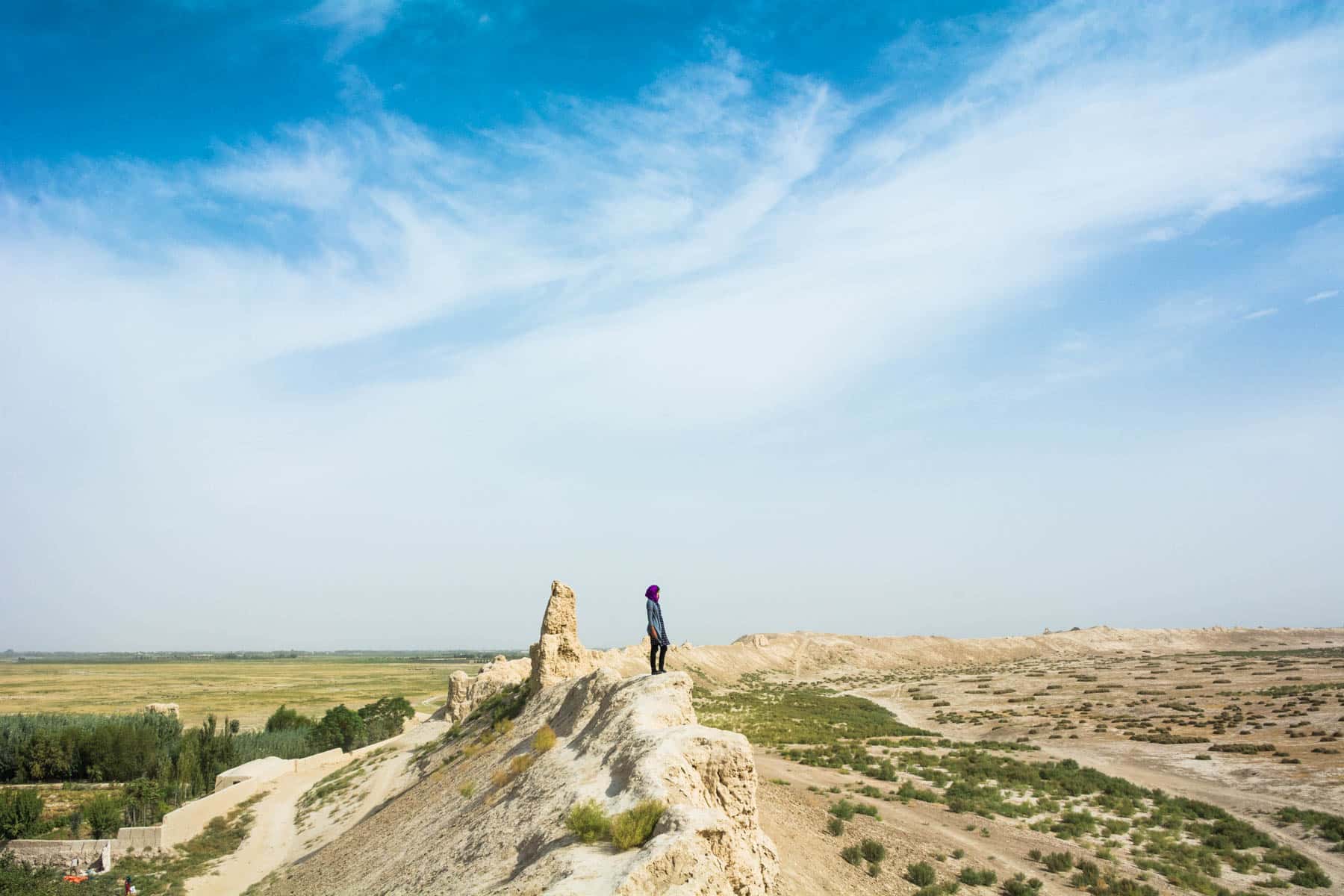 Solo female travel - Alex looking out over Balkh, Afghanistan - Lost With Purpose travel blog