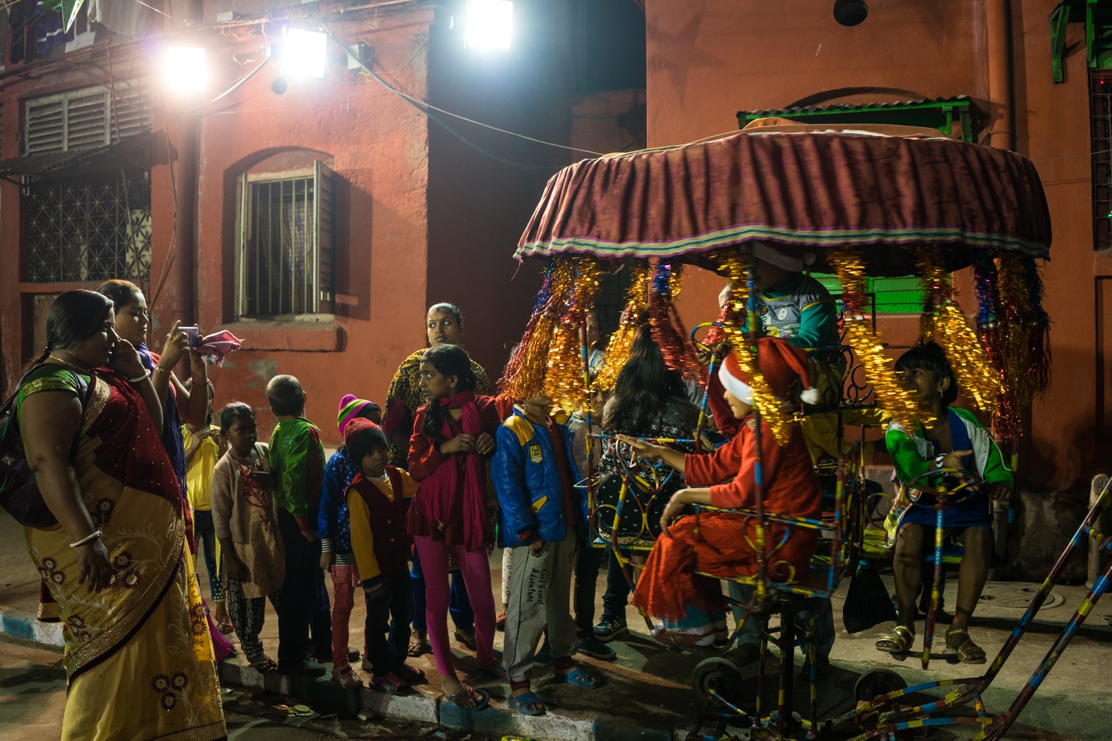 Guide to Christmas in Kolkata, India - Children on an amusement ride in Barracks neighborhood on Christmas Eve - Lost With Purpose travel blog