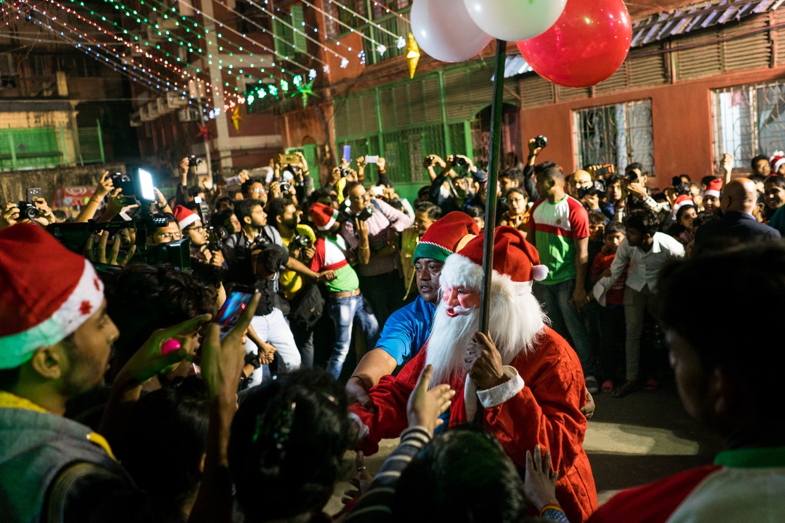 Celebrating Christmas in Kolkata, India - Elf pushing Santa in the crowd at Barracks - Lost With Purpose travel blog