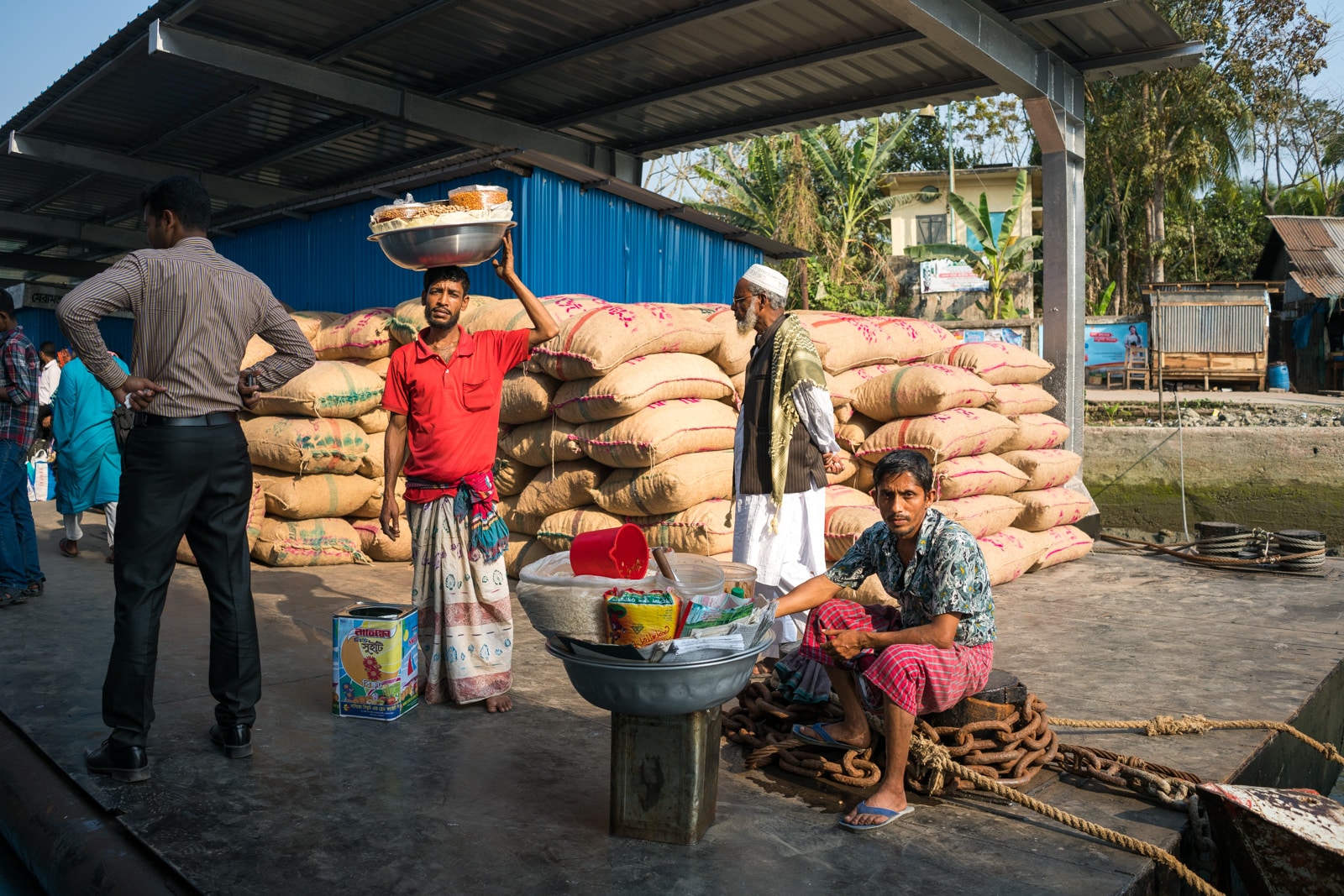 How to get a launch boat from Khulna to Dhaka via Hularhat - Snack salesmen at a dock - Lost With Purpose travel blog