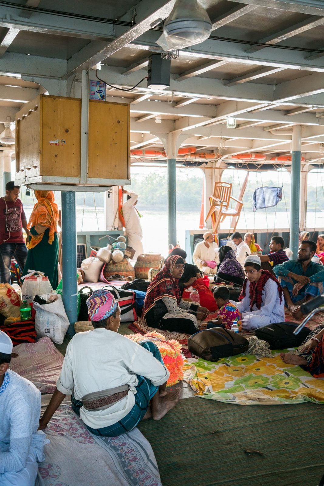 A mat salesman taking a little break between work on a launch boat to Dhaka in Bangladesh.