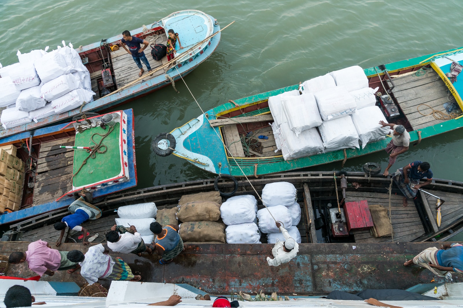 How to get a launch boat from Khulna to Dhaka via Hularhat - People loading cargo onto the launch in Bangladesh - Lost With Purpose travel blog