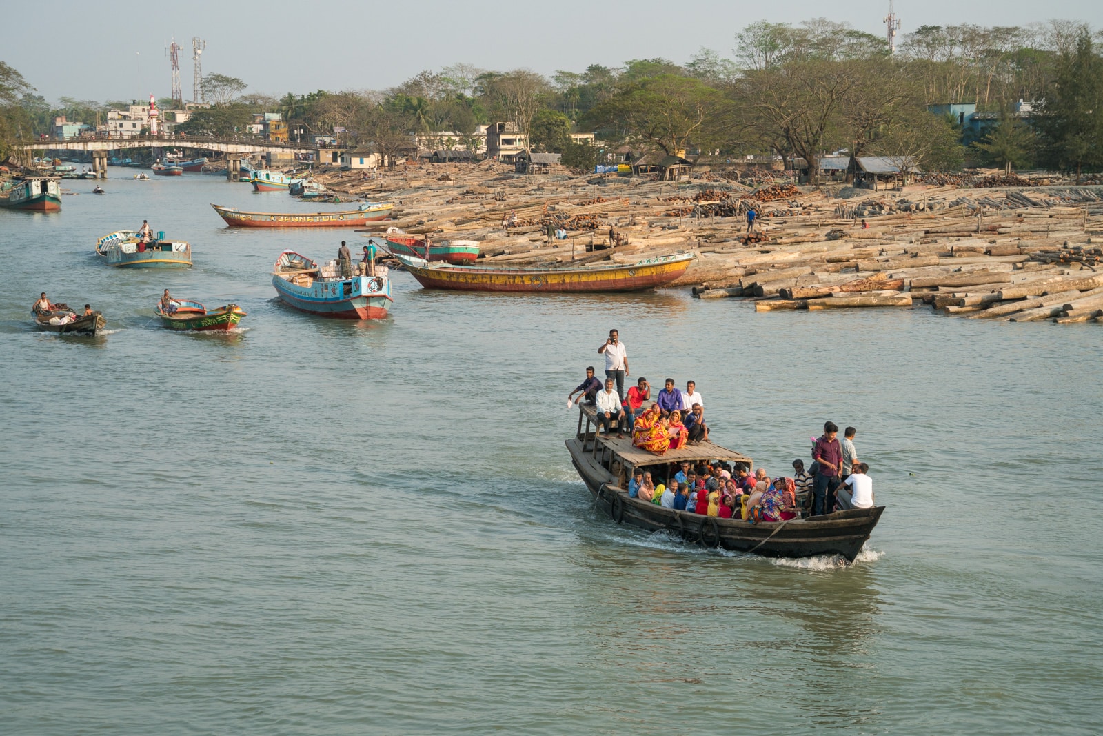 How to take a launch boat from Khulna to Dhaka via Hularhat, Bangladesh - Boats sailing through a lumber yard - Lost With Purpose travel blog