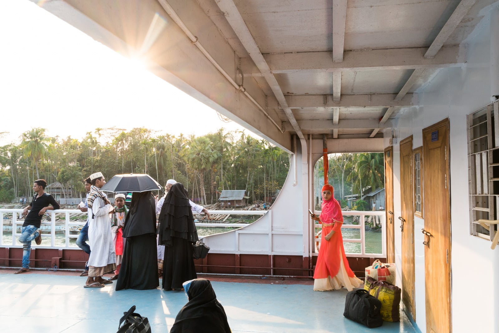 Launches from Hularhat to Dhaka, Bangladesh - Women in burqa looking out from the boat deck - Lost With Purpose travel blog