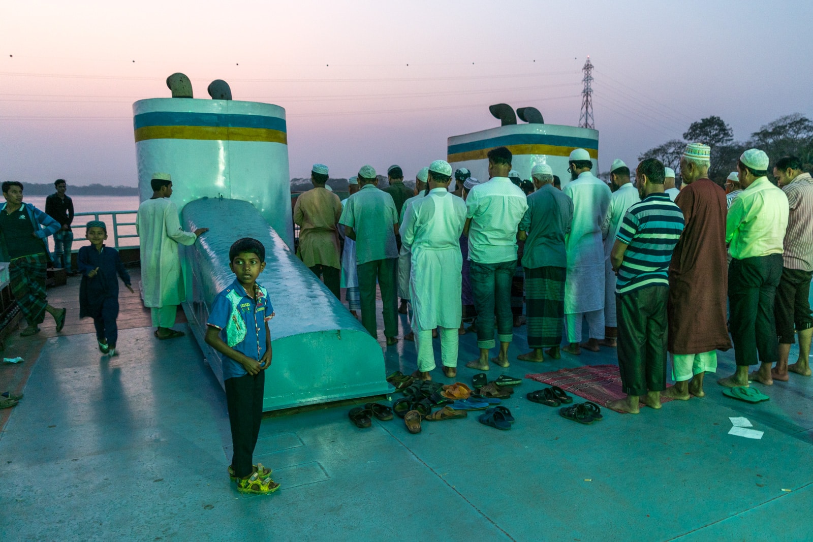 Launches from Hularhat to Dhaka, Bangladesh - Men praying on the boat - Lost With Purpose travel blog