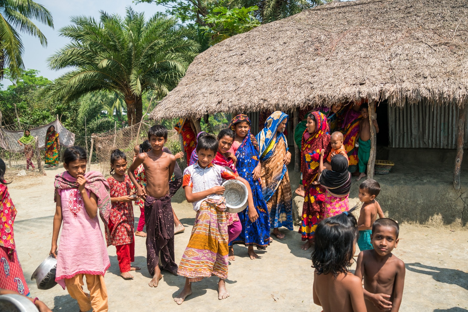 Guide to Nijhum Dwip, Bangladesh - Villagers outside a hut - Lost With Purpose travel blog