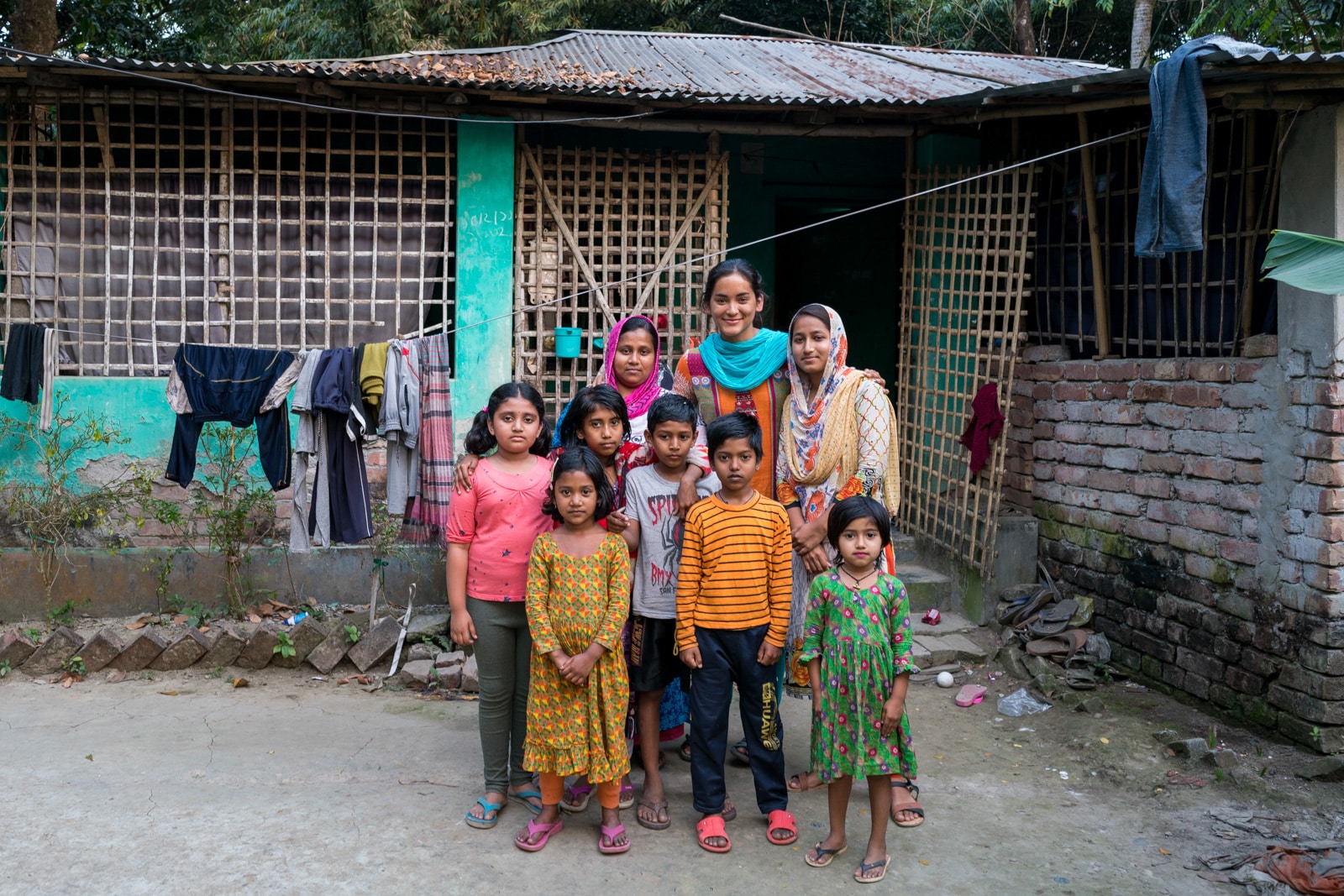 Is Bangladesh safe for female travelers - Alex chilling with a family in a village outside of Khulna - Lost With Purpose travel blog