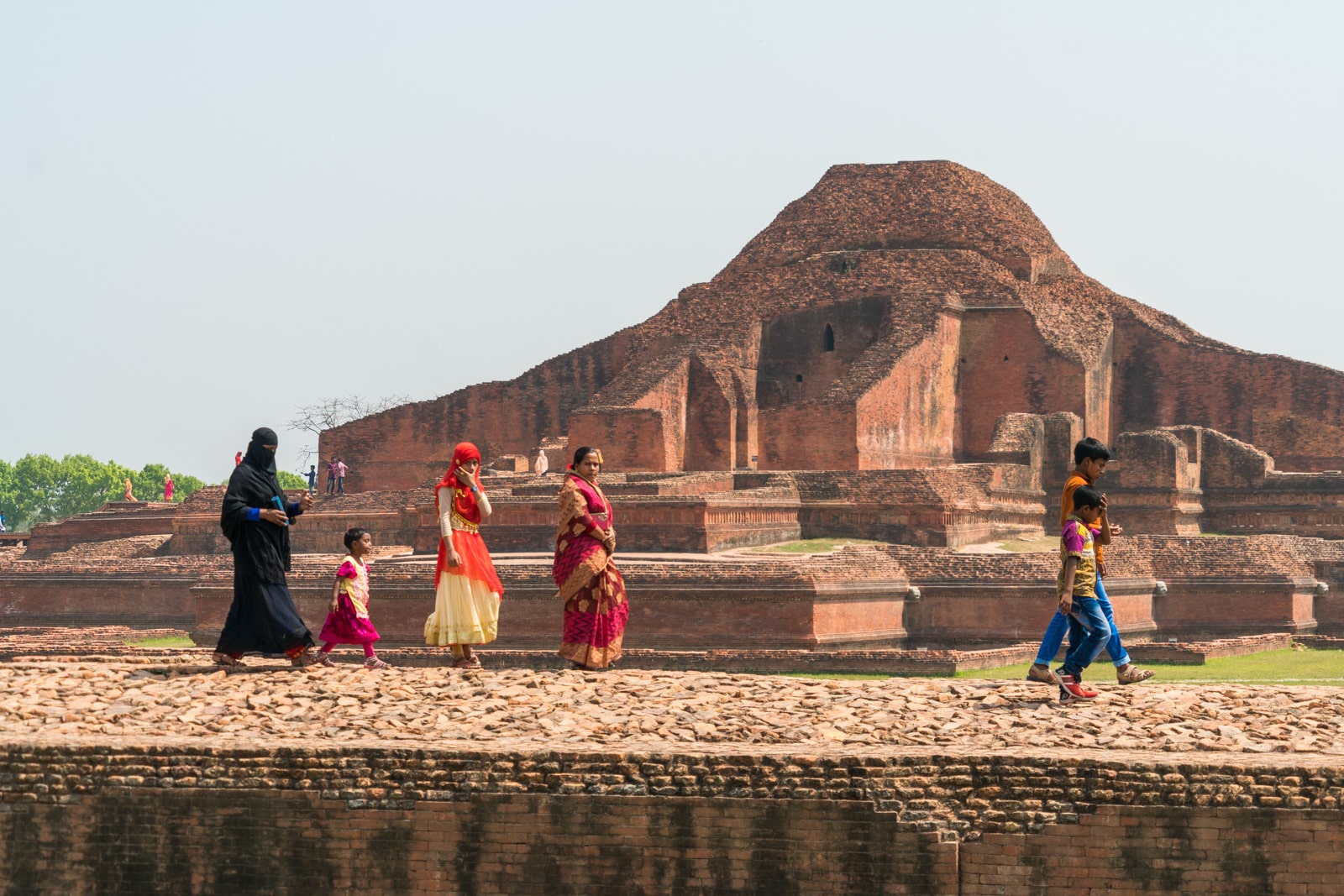 Backpacking in Bangladesh travel guide - Muslim family walking by Buddhist ruins of Sompur Mahavihara - Lost With Purpose travel blog