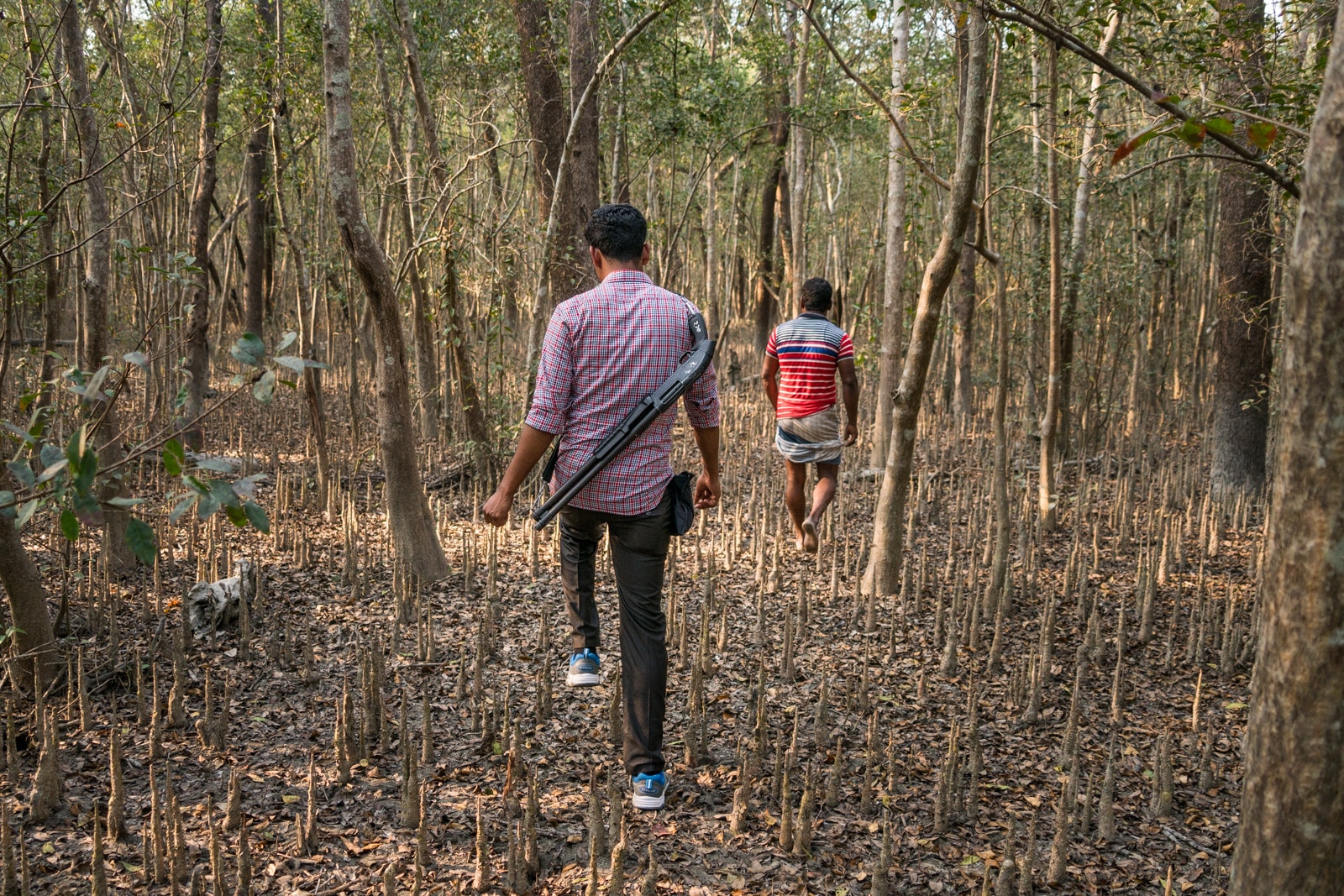 Solo female travel in Bangladesh - Guard with gun walking in Nijhum Dwip National Park - Lost With Purpose travel blog