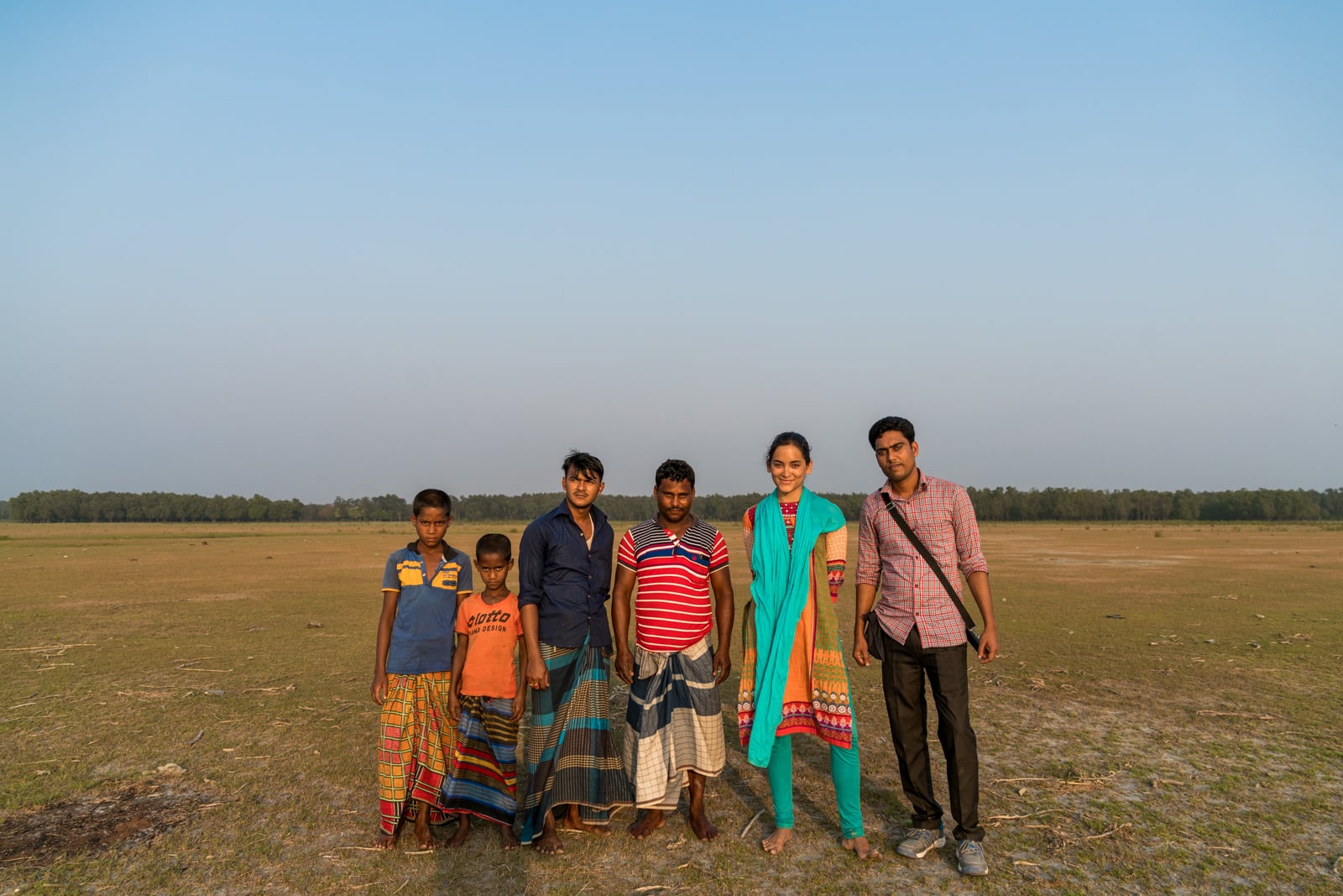 Guide to solo female travel in Bangladesh - Alex with a group of men in Nijhum Dwip - Lost With Purpose travel blog