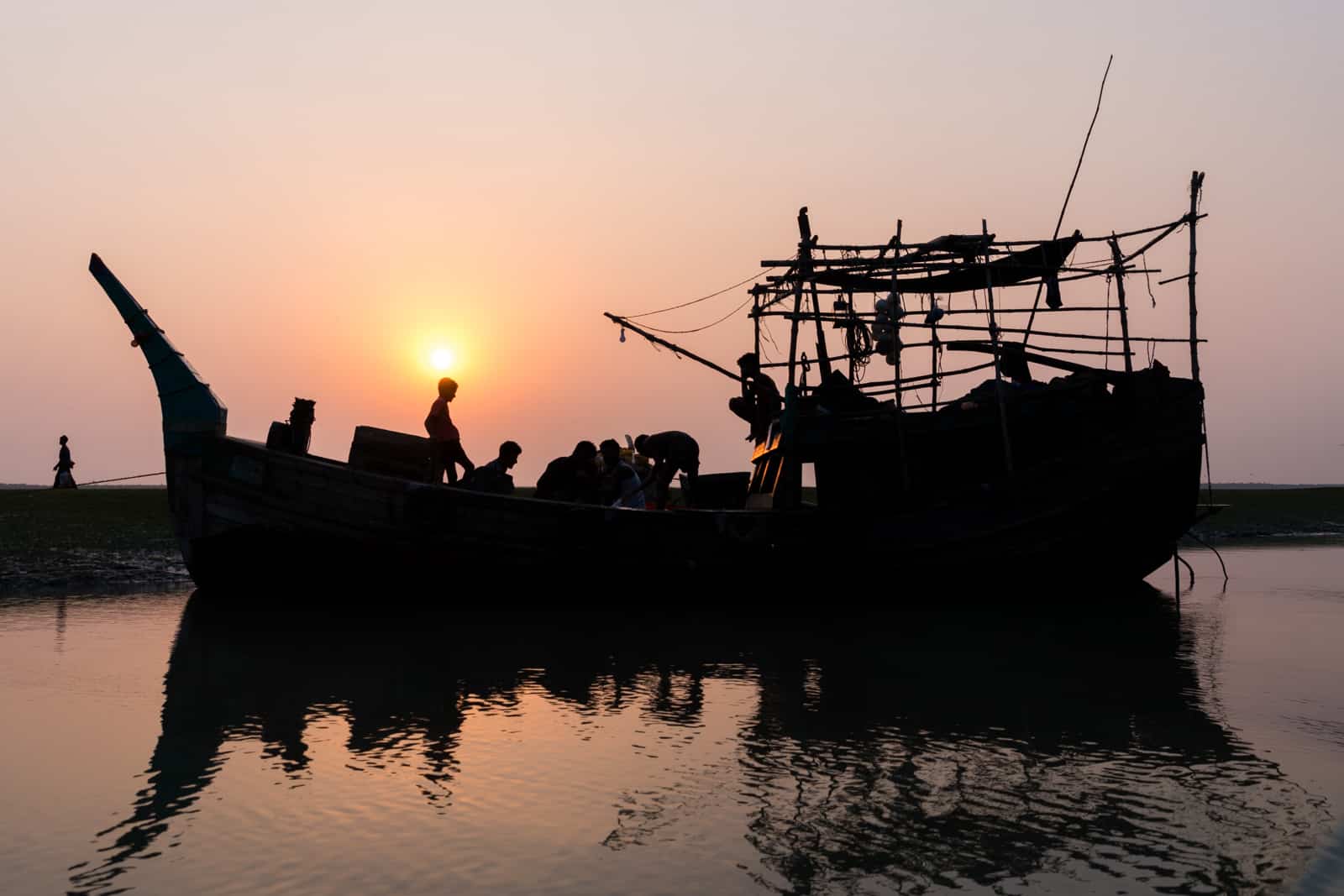 Travel guide to Nijhum Dwip, Bangladesh - Sunset behind fishing trawler boats on the island - Lost With Purpose travel blog