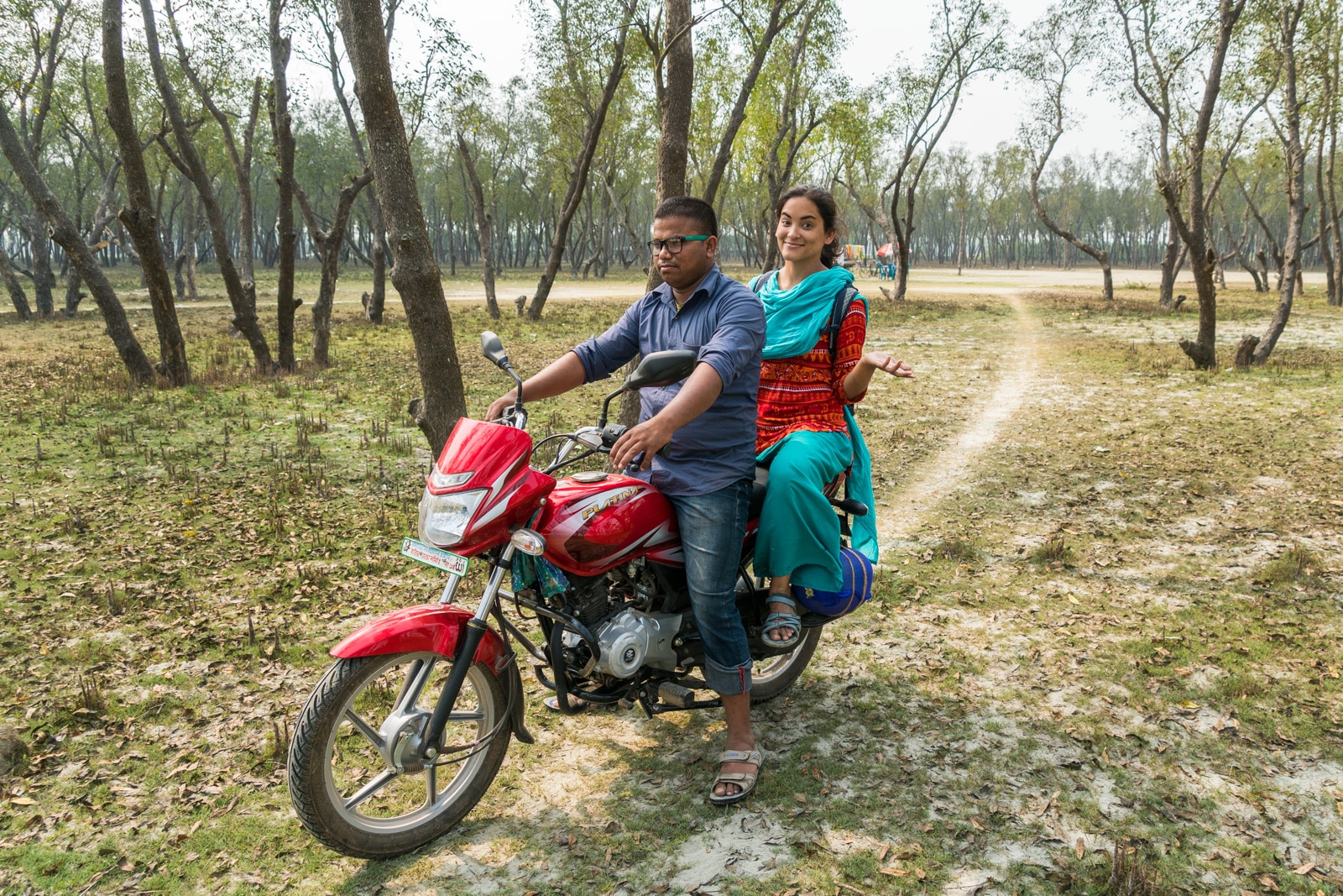 Guide to solo female travel in Bangladesh - Alex on a motorbike with her manescort - Lost With Purpose travel blog