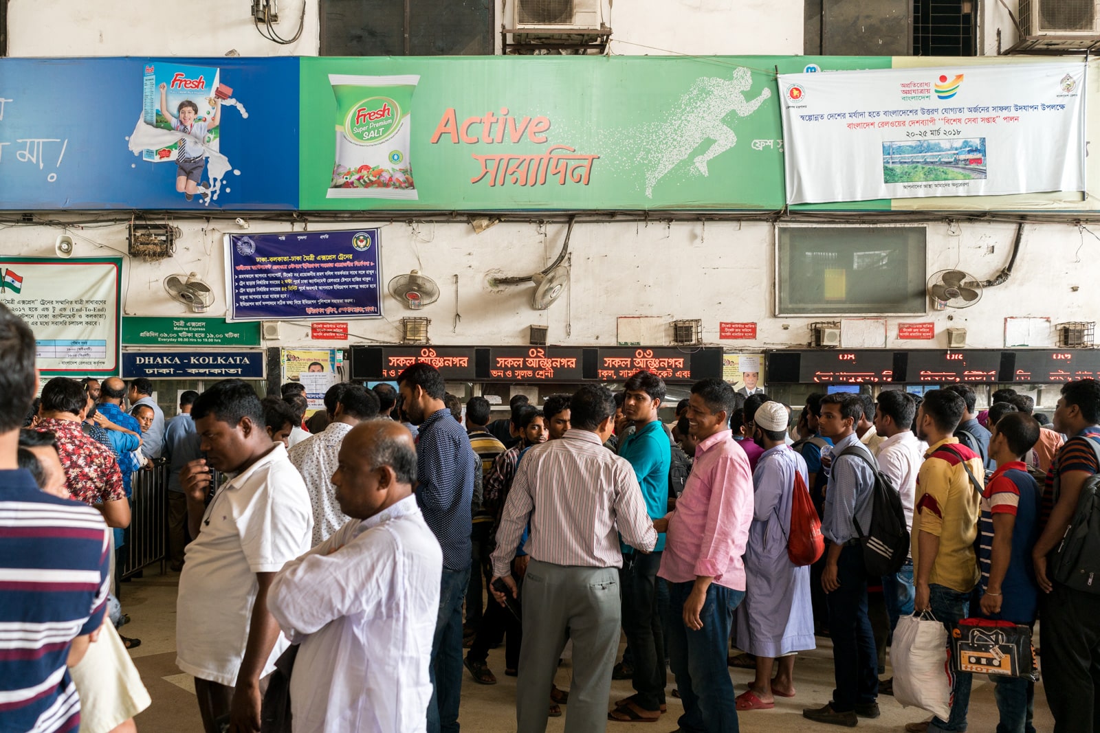 How to take the train from Bangladesh to India - Ticketing windows at Dhaka Kamalapur railway station - Lost With Purpose travel blog