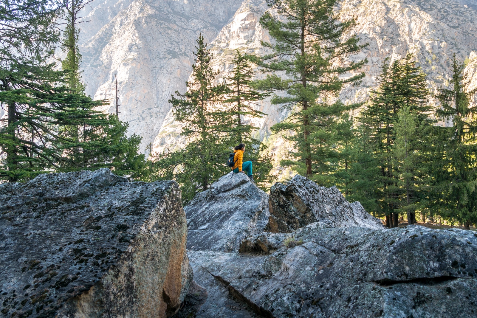 Easy ways to travel more responsibly - Alex on rocks in Gangotri - Lost With Purpose travel blog