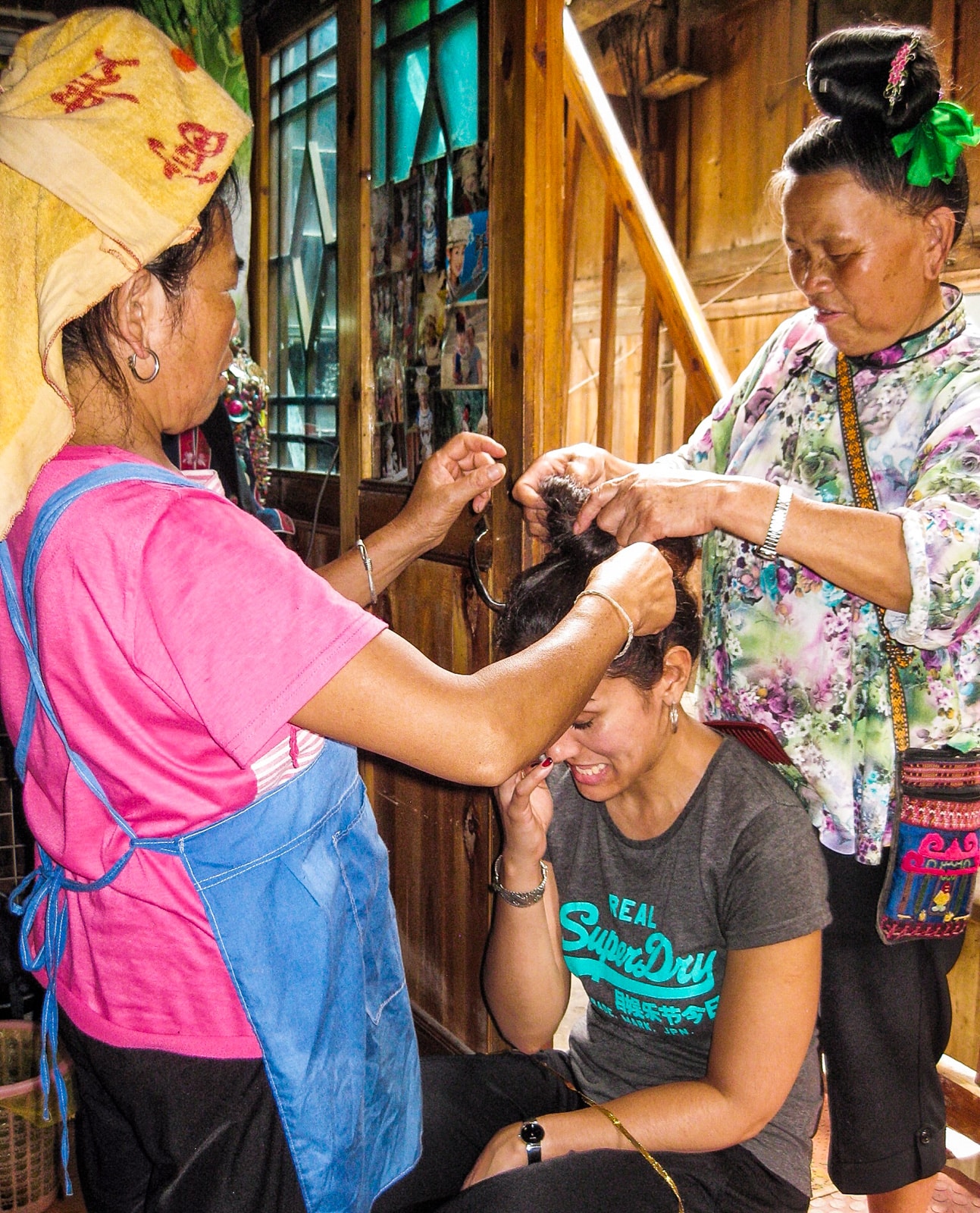 Exploring off the beaten track villages in Guizhou, China - Hair done by ladies in Langde