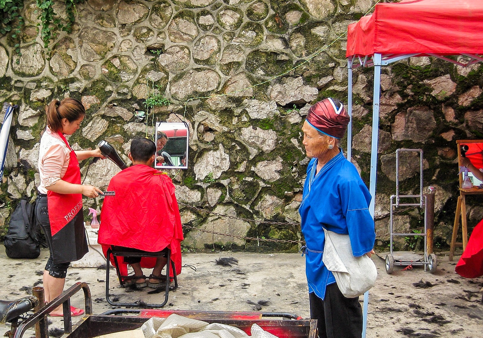 Exploring off the beaten track villages in Guizhou, China - Barber in Kaili