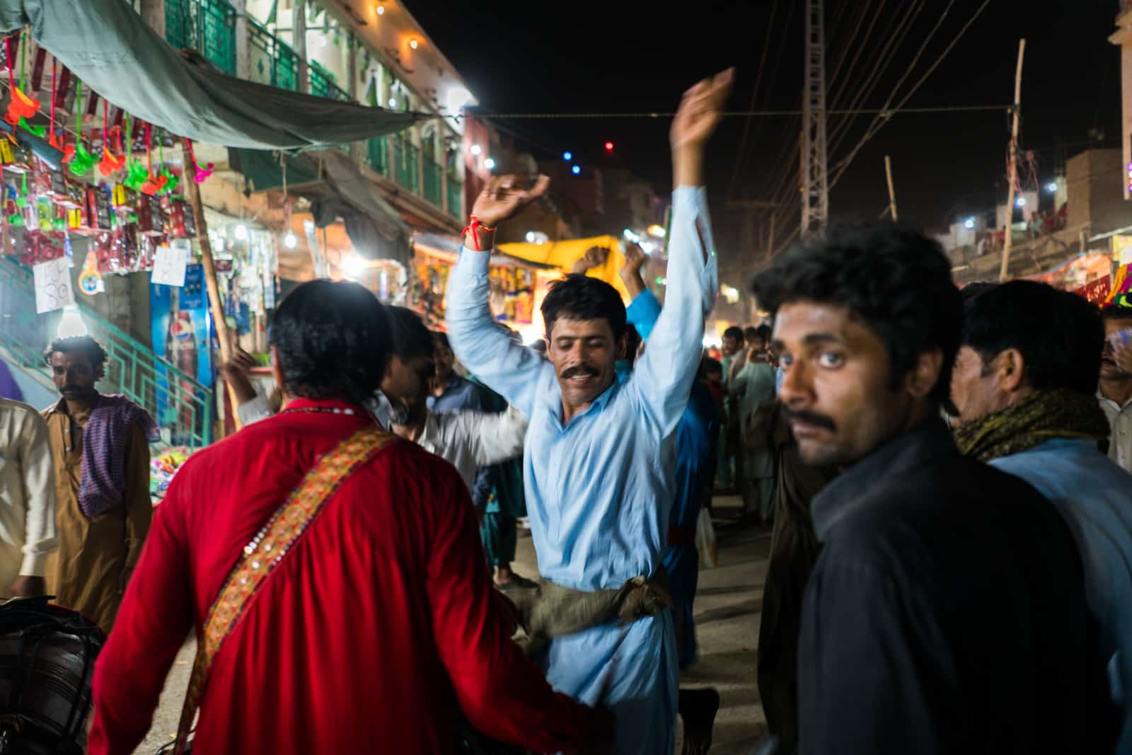 The Urs of Lal Shahbaz Qalandar in Sehwan, Pakistan - Man dancing on the streets of Sehwan at night - Lost With Purpose travel blog