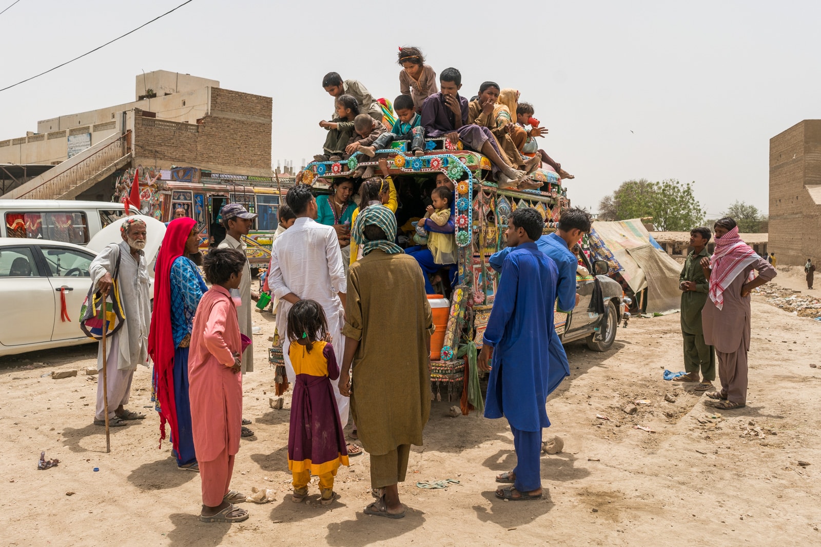 The Urs of Lal Shahbaz Qalandar in Sehwan, Pakistan - Family squishing onto a bus - Lost With Purpose travel blog